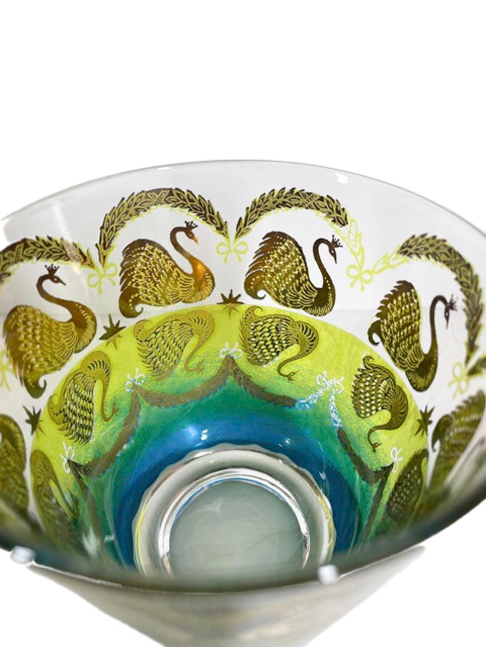Eight old fashioned glasses made by Cera Glassware and decorated in 22k gold with swans swimming below arched floral swags, the water created with yellow and blue translucent enamels combining to create green through the center. An inverted image of