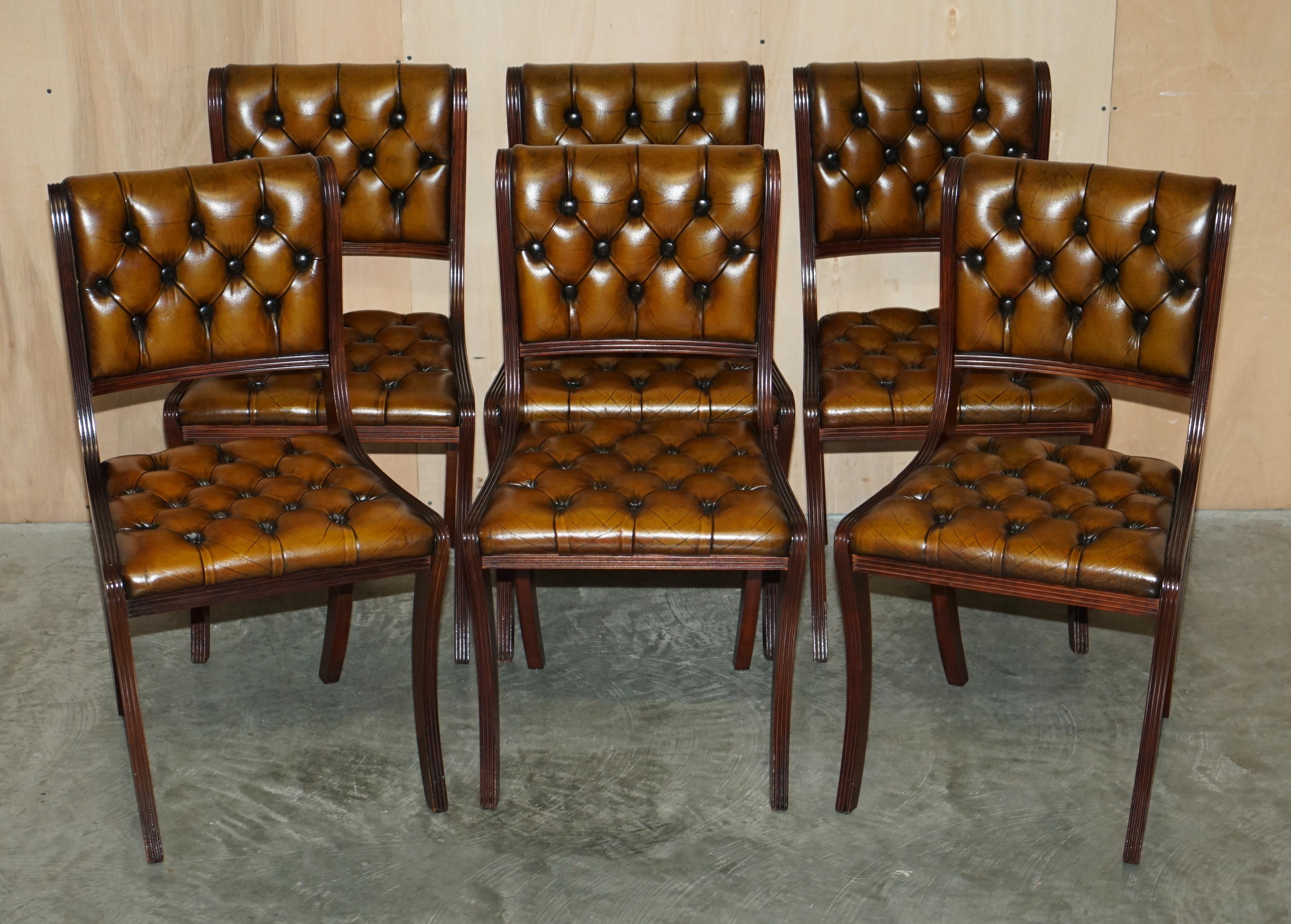 We are delighted to offer for sale this stunning suite of eight Regency style vintage fully restored Chesterfield aged cigar brown leather dining chairs in mahogany.

An absolutely sublime suite of eight vintage dining chairs. They are as
