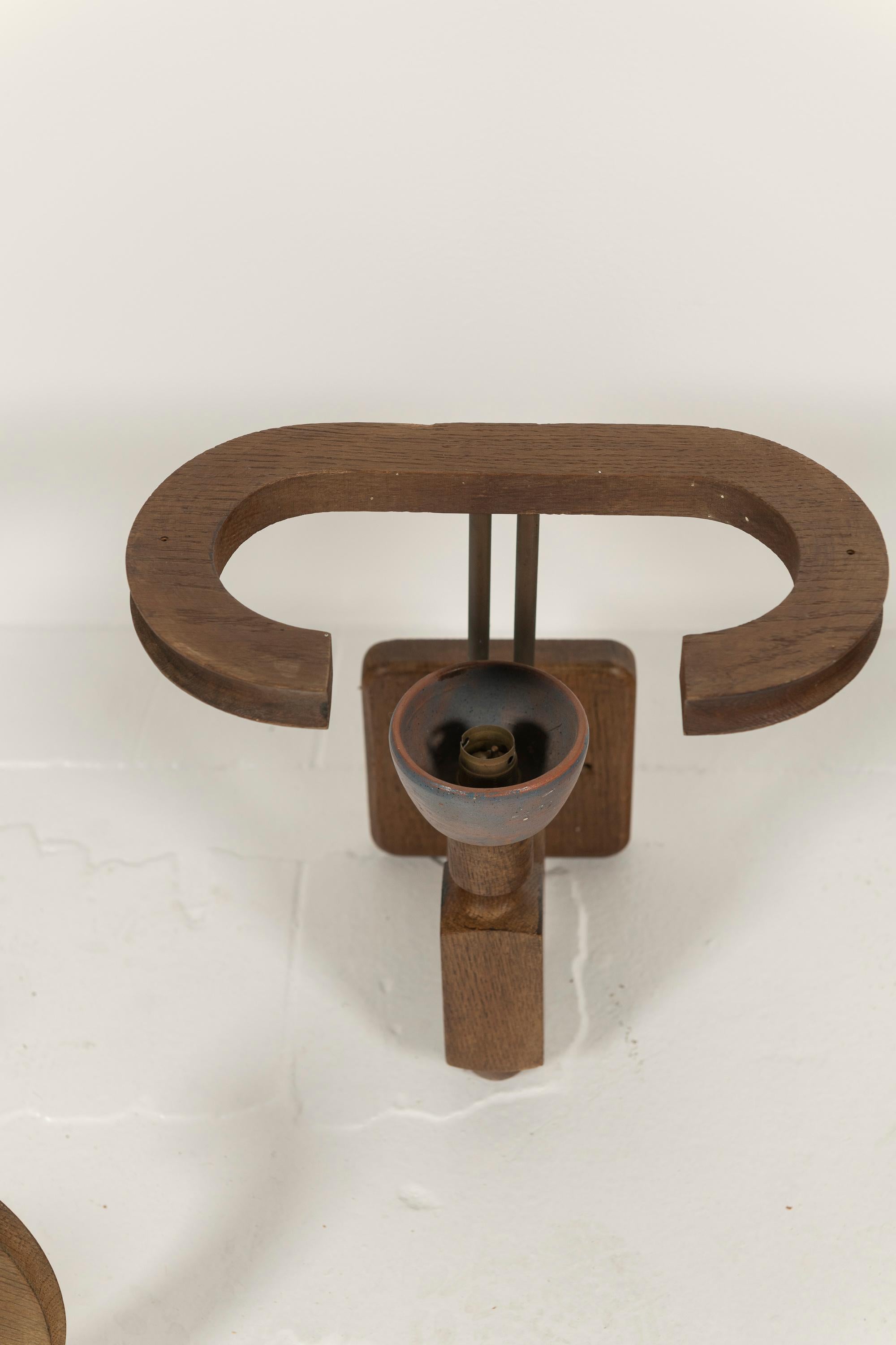 Eight Unique Mid-Century Modern Oak and Ceramic French Sconce designed by Guillerme et Chambron for Votre Maison, France, circa 1960s. These flight fixtures have ceramic bulb holders in several colors designed by Danikowski while metal rods hold the