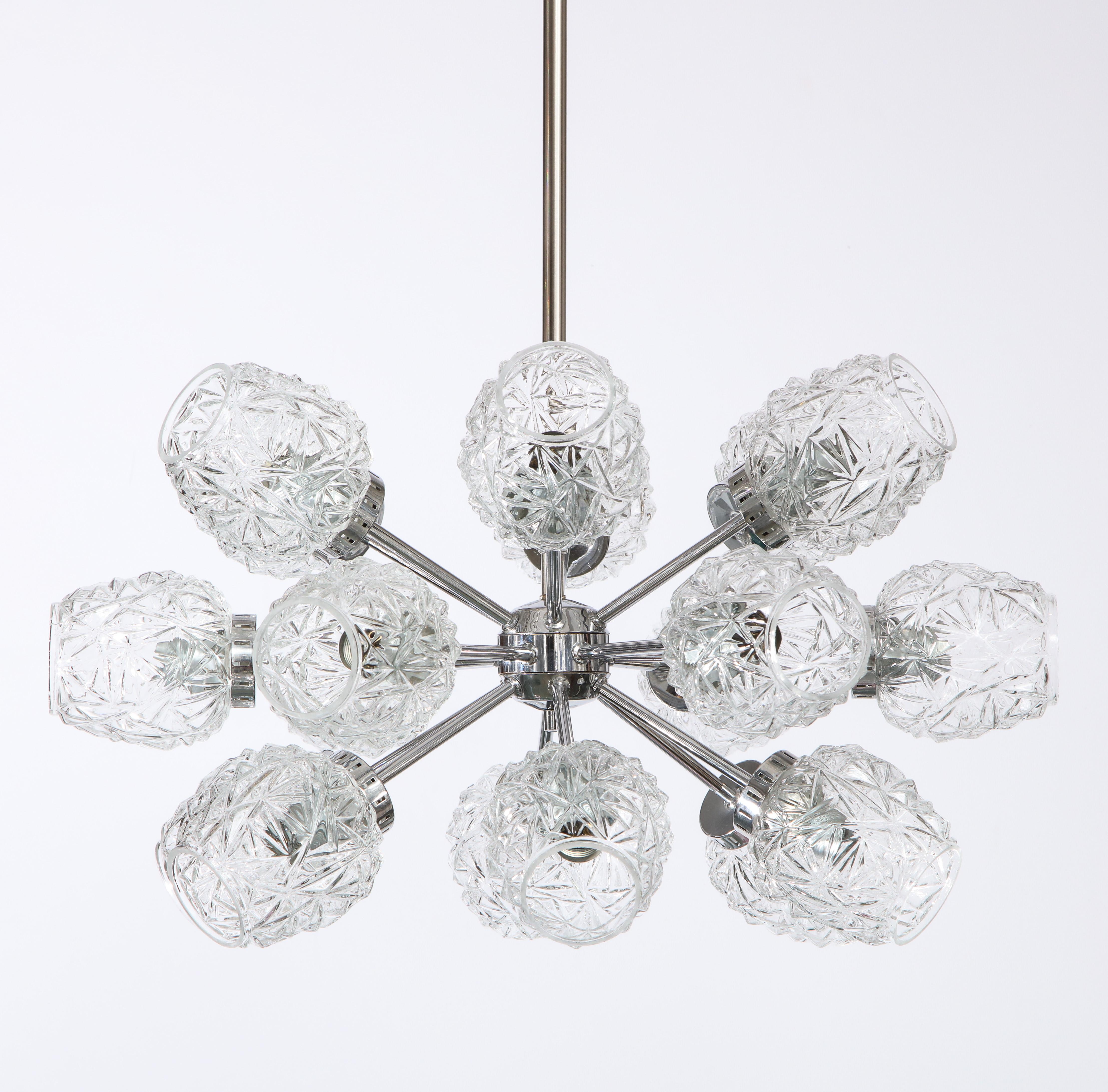 Elegant chrome eighteen cut glass globe sputnik chandelier.
The fixture has been newly rewired but retains the E14 bulb sockets.
It comes complete with matching ceiling canopy and rod which can be customized to your specific length.