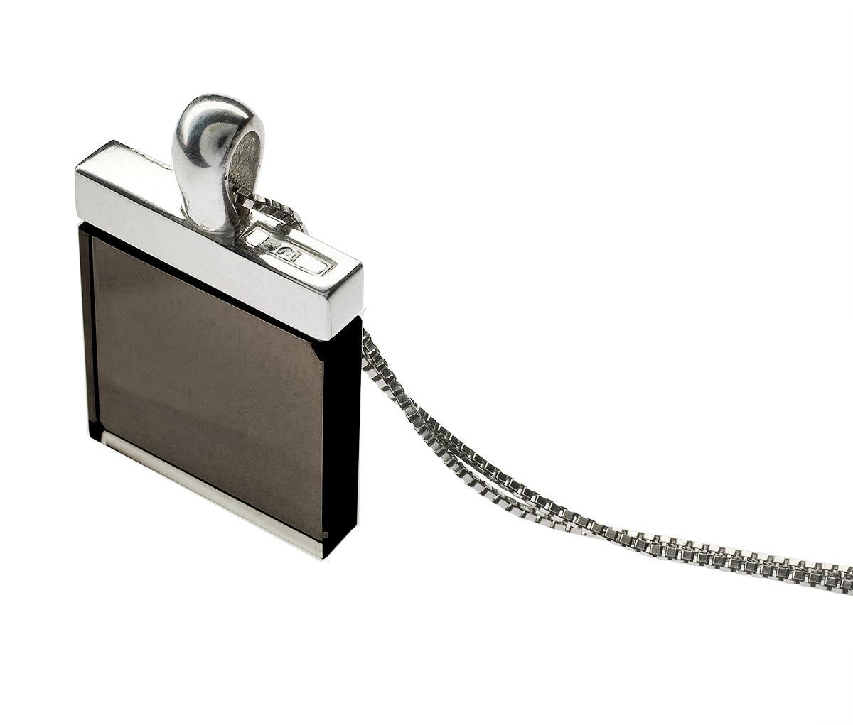 This designer pendant necklace from the Ink collection features a smoky quartz set in 18K white gold. The large 15x15x3 mm stone is cut in a unique shape that evokes the art deco style, while the overall design is contemporary and fashionable. The