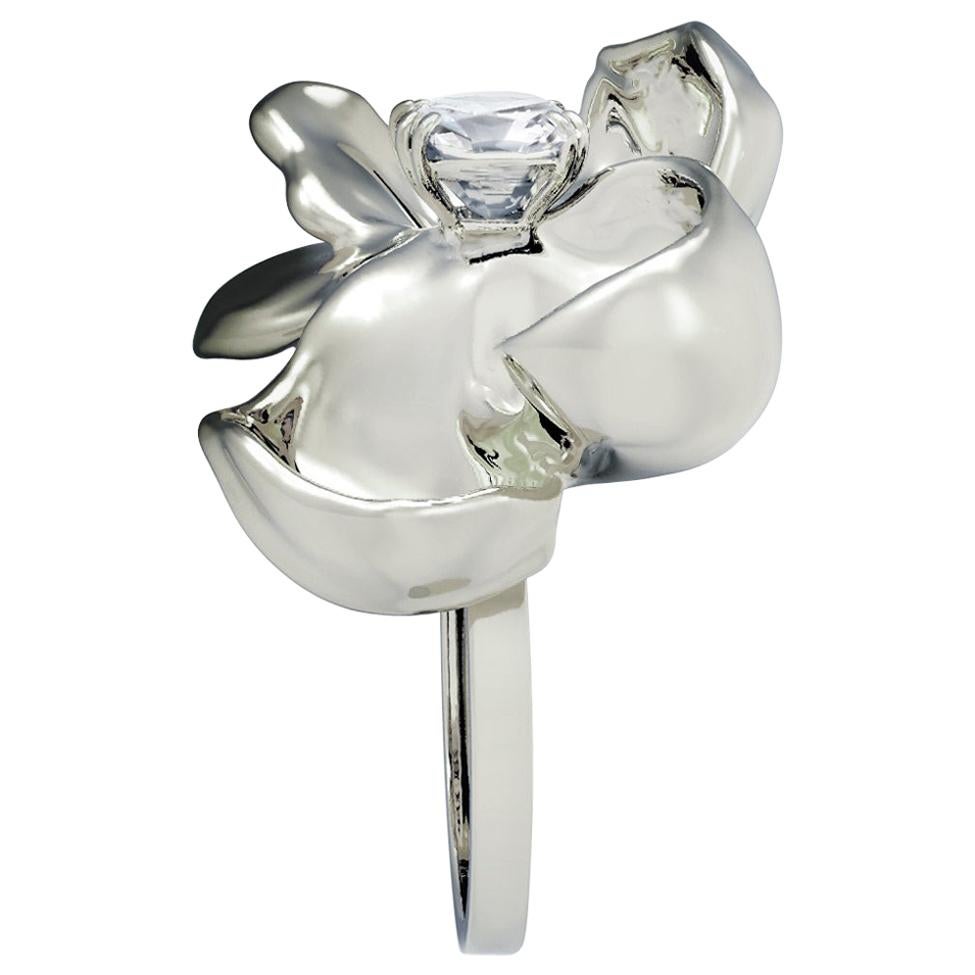 This Magnolia Flower engagement ring is crafted in 18-karat white gold, featuring a cushion-cut transparent sapphire (white). The limited edition ring is designed by Polya Medvedeva, an oil painter and 3D jewelry designer. 

Despite its size and