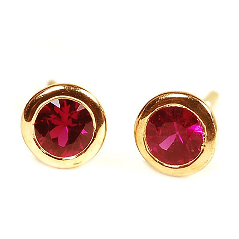 Eighteen Karat Yellow Gold Bezel Set Ruby Stud Earrings For Sale at 1stdibs