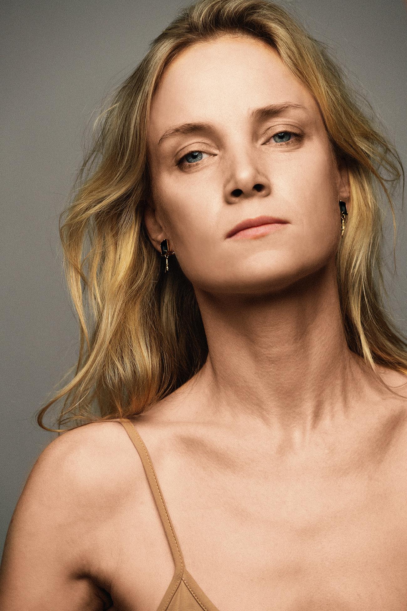These contemporary stud dangle earrings feature natural sapphires (octagon cut) and belong to the Tea collection, which was featured in a published issue of Vogue UA. The earrings are made of 18 karat yellow gold and were designed by the