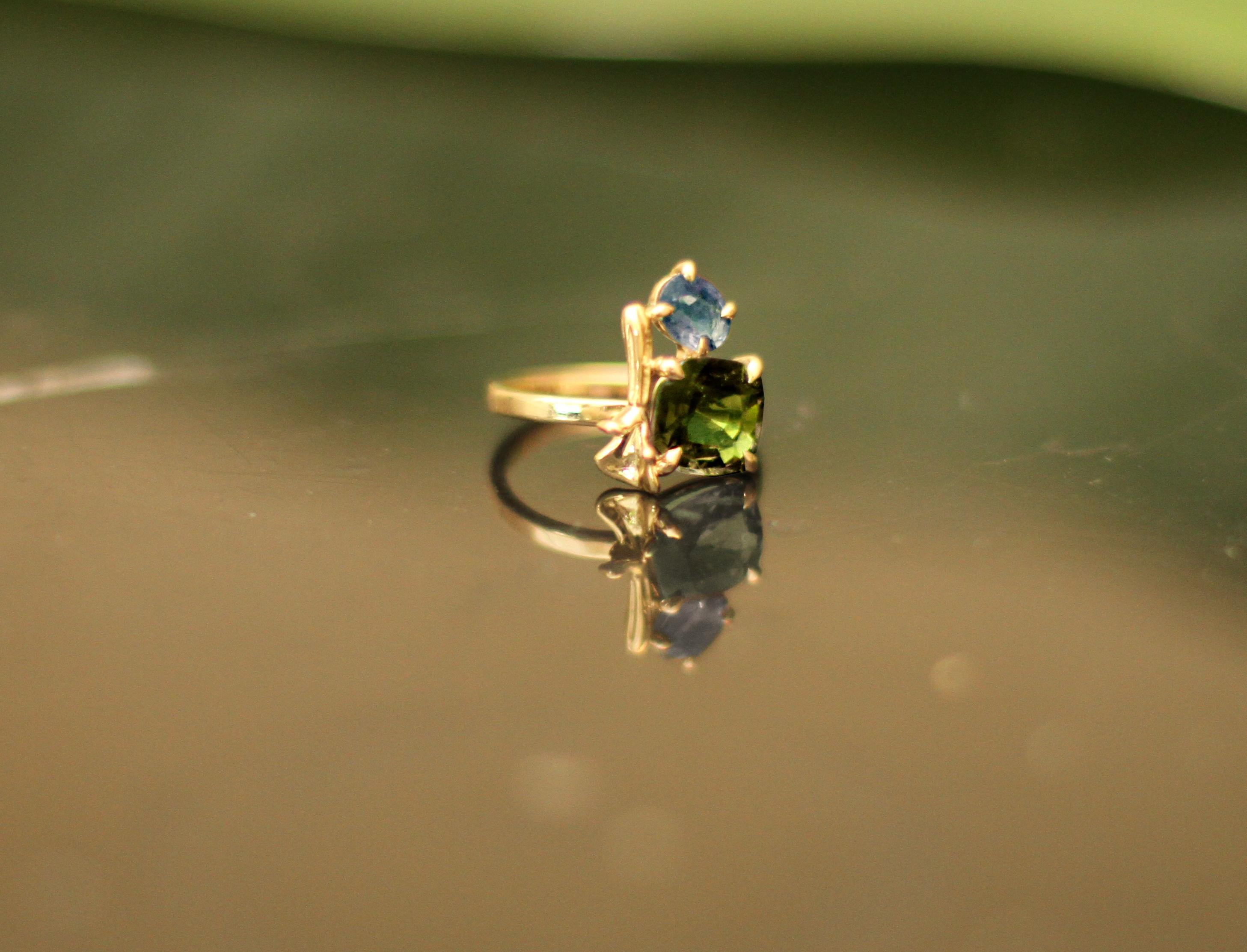Dieser zeitgenössische lavendelfarbene Ring ist aus 18 Karat Gelbgold mit passendem grünen Turmalin im Kissenschliff und blauem Topas im Ovalschliff. Es gehört zu einer Kollektion mit kleinen goldenen skulpturalen Elementen, die in der Vogue UA