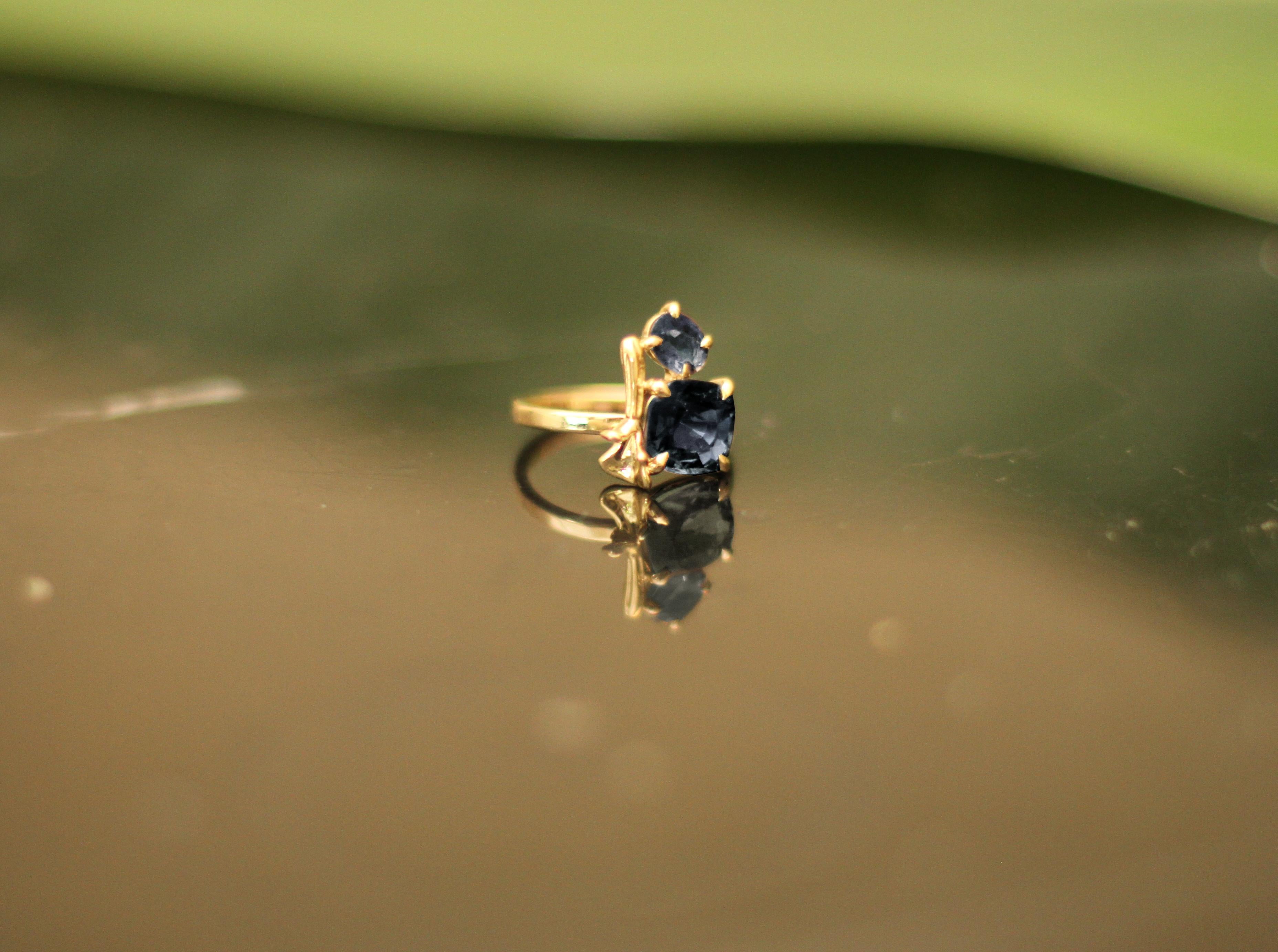 This contemporary lavender ring is in 18 karat yellow gold with matching iolites in cushion and oval cut. It belongs to a collection with tiny golden sculptural elements, which was featured in Vogue UA. 

The ring is easy to wear, and the gems catch