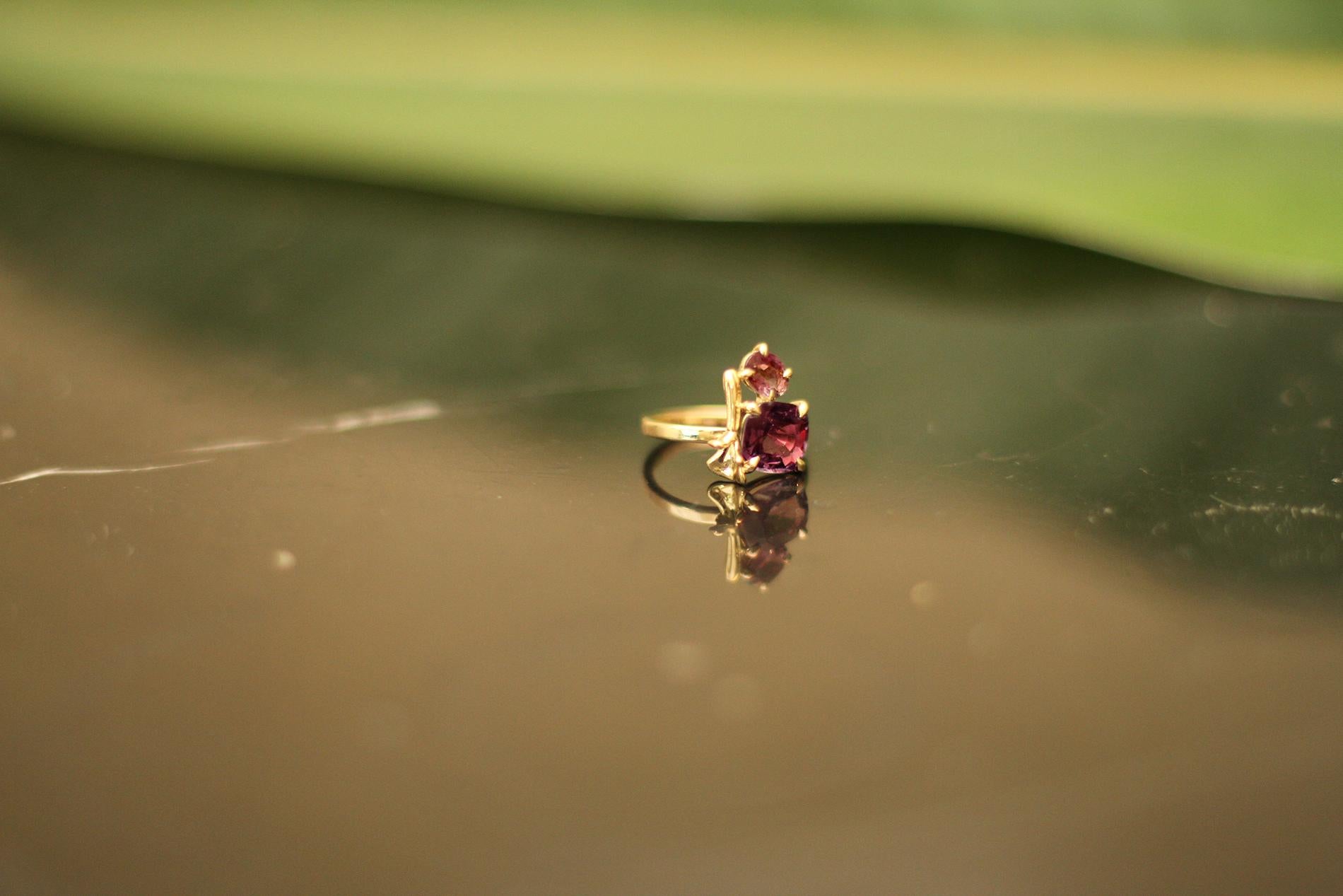 This contemporary lavender ring is in 18 karat yellow gold with matching red tourmalines in cushion cut and oval cut. It belongs to a collection with tiny golden sculptural elements, which was featured in Vogue UA. 

The ring is easy to wear, and