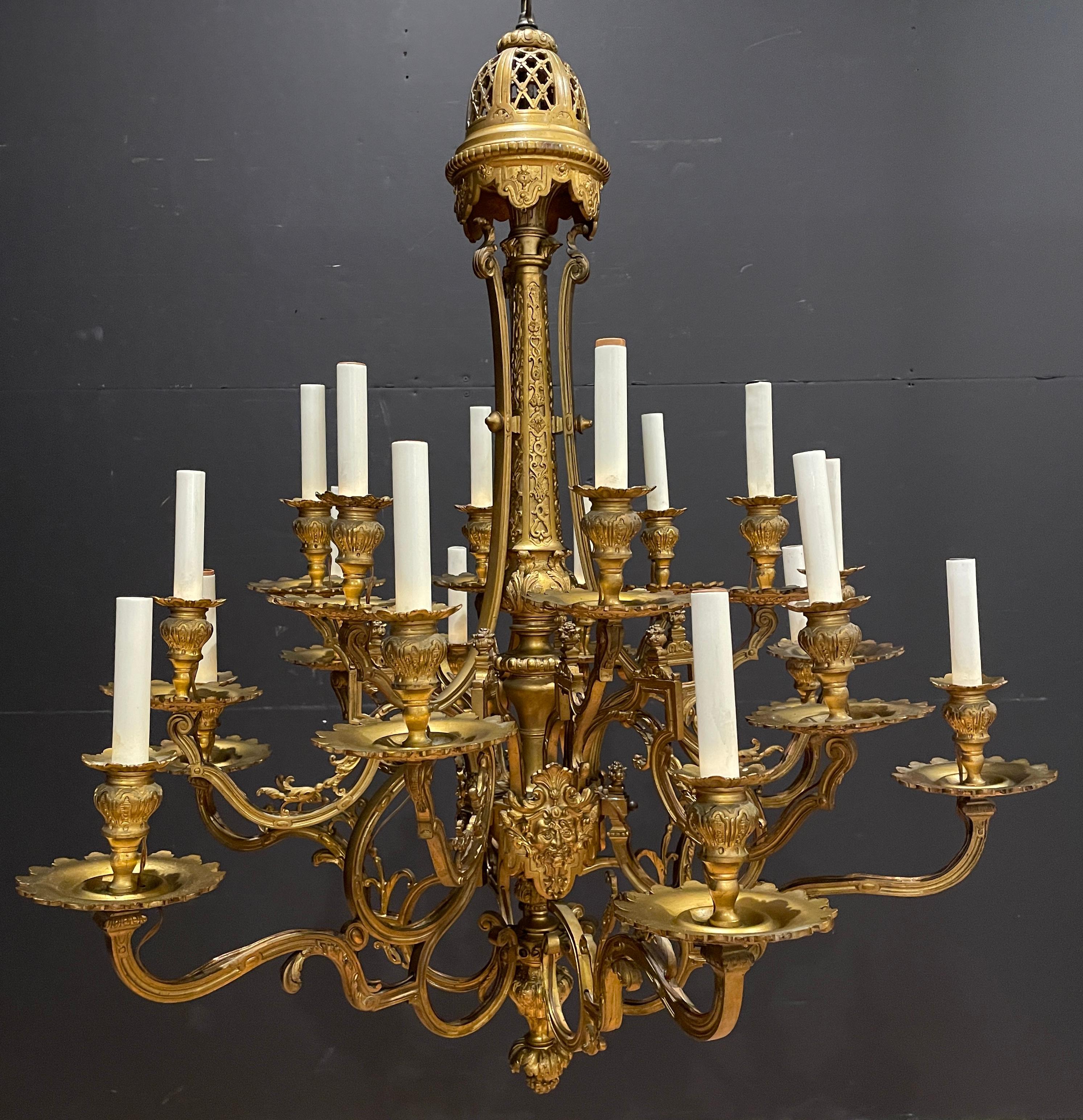Fine quality 19th century gilt bronze 18 light chandelier. Having Baccus masks surrounding the central body, this chandelier has a Renaissance feel with some Louis XVI influence. Originally made to be fit for candles, it had later been converted and