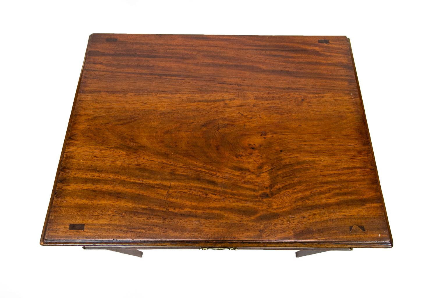 This unique table has the original finish and patina. The top has an ogee molded edge. The drawer is crossbanded with mahogany and has boxwood edging and string inlay. The drawer also has its original hardware and pulls out to reveal two drop
