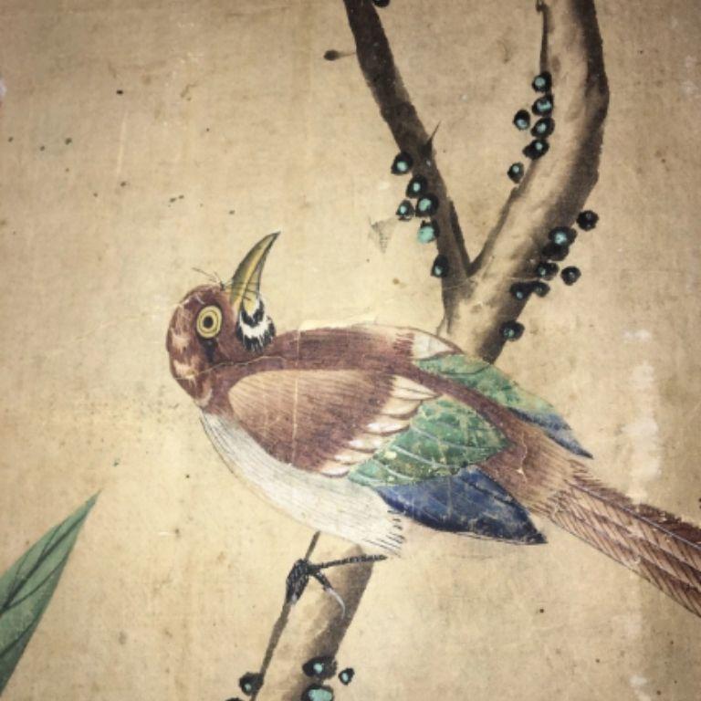 A stunning and tall three-panel screen made of 18th century hand painted Chinese wallpaper laid on canvas. Dates 1775-1800. There is some wear, as expected, but the overall effect is stunning, with birds, blossoms and foliage. The reverse is painted