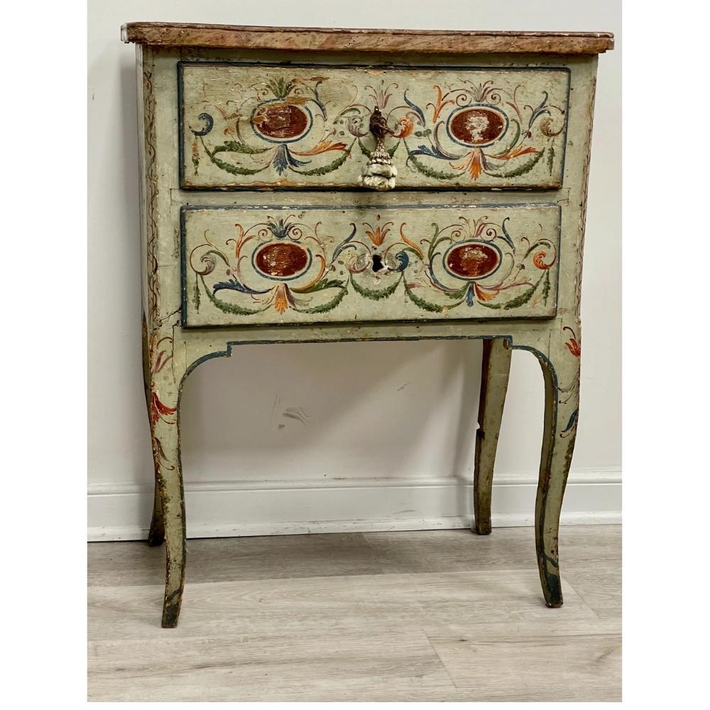 Delightful and rare 18th C. Italian Venetian painted side cabinet or commodini having original pale green paint and darker green and gold/ochre scrolling foliate designs, paint. The square faux marble painted top over two drawers, the top drawer