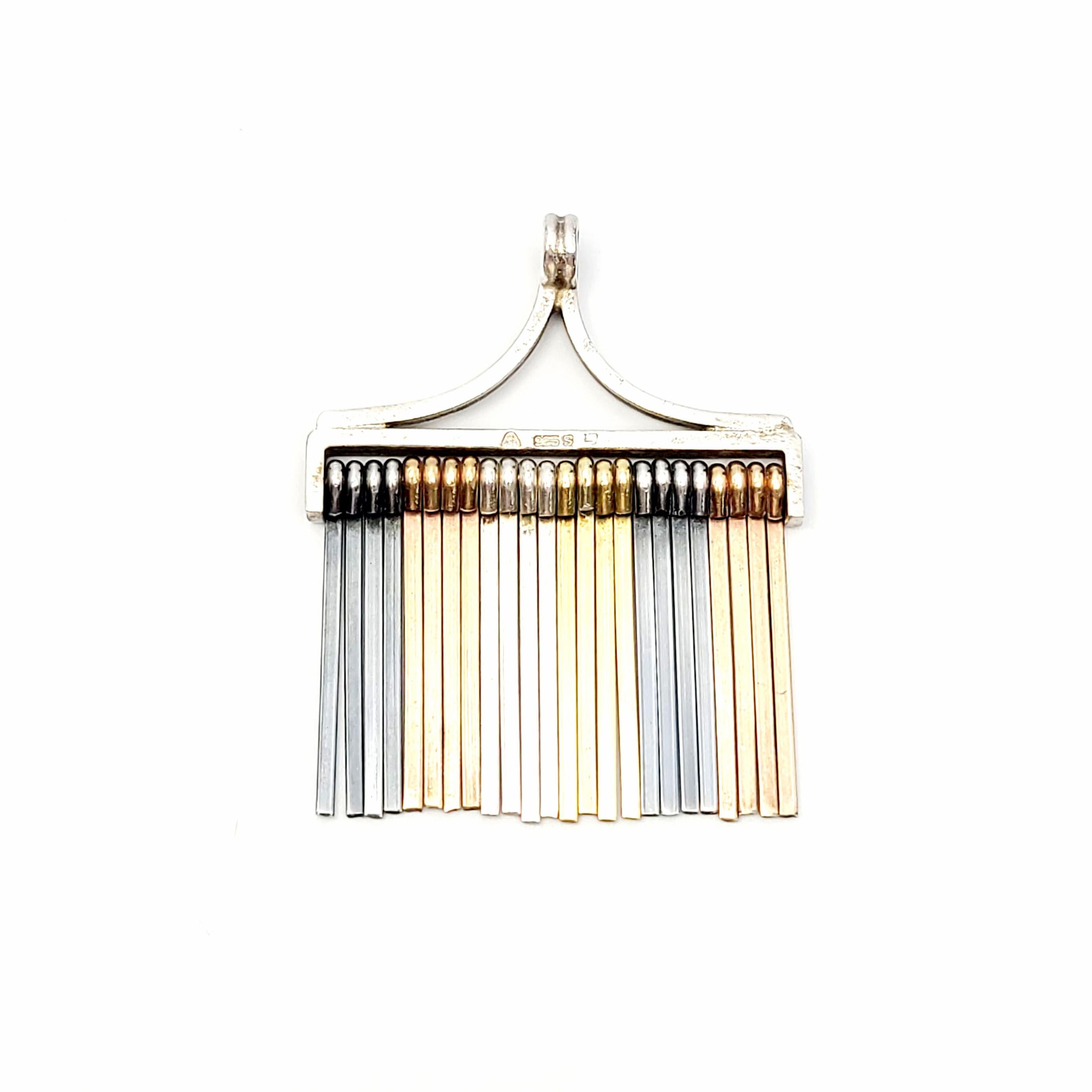 Vintage Four Color sterling silver fringe pendant designed by Eigil Jensen for Anton Michelsen of Denmark.

Sterling silver tines hang in four color groups: silver, oxidized silver, plated in gold and plated in rose gold. Circa mid-late 20th