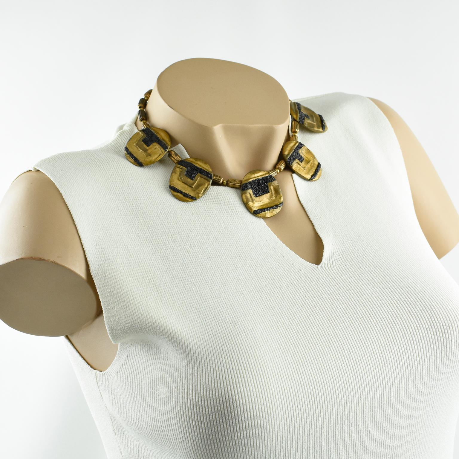 This stunning sculpture choker necklace was designed by American artist Eileen Aubi in 1961. The gilded coating resin pebbles with a hand-made feel are topped with black stone chips and complemented with gilded metal beads. The hand-written
