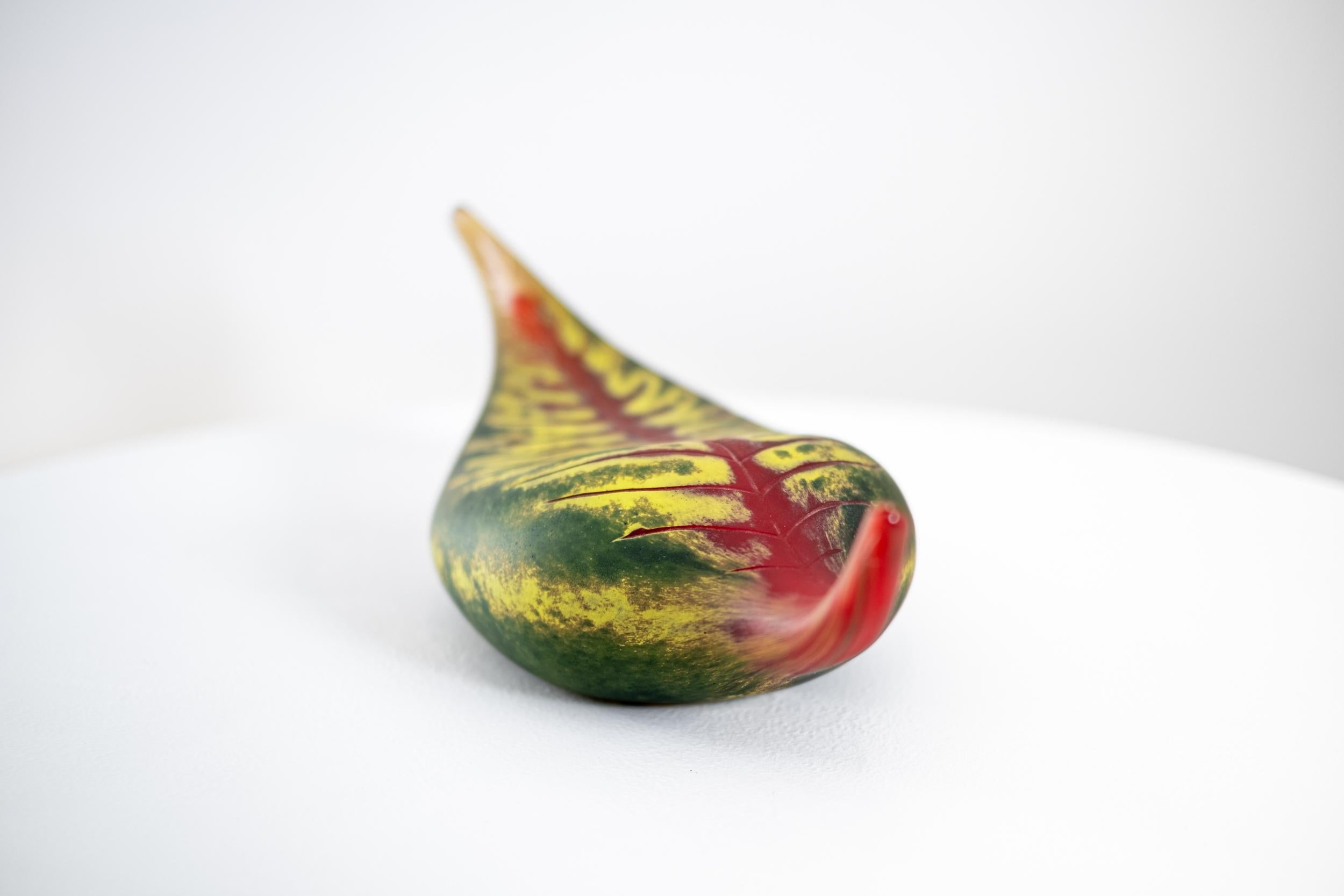 This contemporary, still-life, blown glass, sculpture of a leaf was hand-crafted by artist Eileen Gordon.

Australian glass artist Eileen Gordon’s leaf in jewel tones of red and forest green captures the lovely organic shape of a fallen leaf. As if