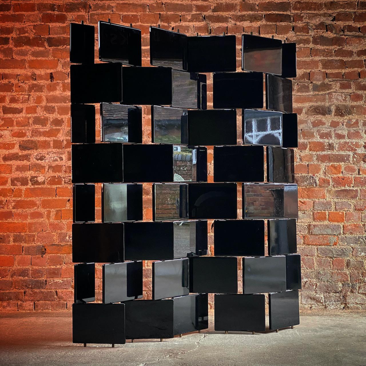 Eileen Gray brick screen room divider, circa 2000

Incredible Eileen Gray 'Brick Screen', after the original 1920s design Italy circa 2000, the folding screen or room divider made in Japanned black lacquered wood moveable panels on a brass