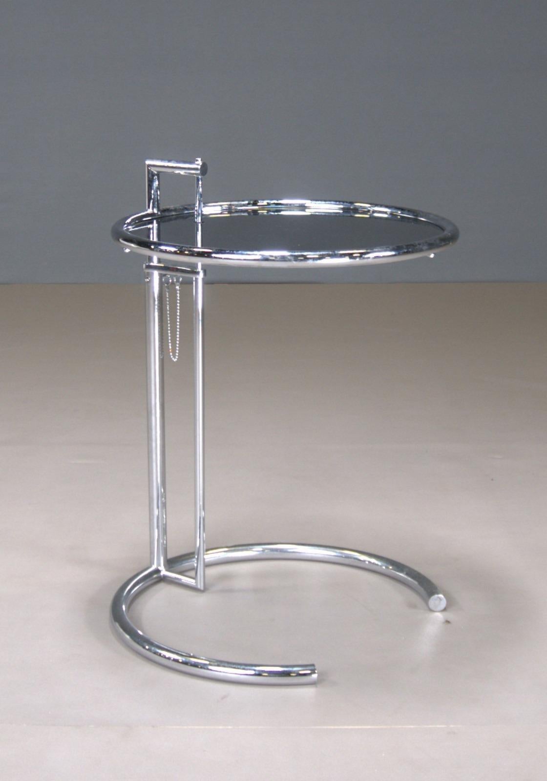 Eileen Gray Chrome Glass Side Table: Designed by Eileen Gray in 1927, this side table is a classic of modern design. The chrome and glass construction provides a sleek and timeless look. Perfect for contemporary living spaces.