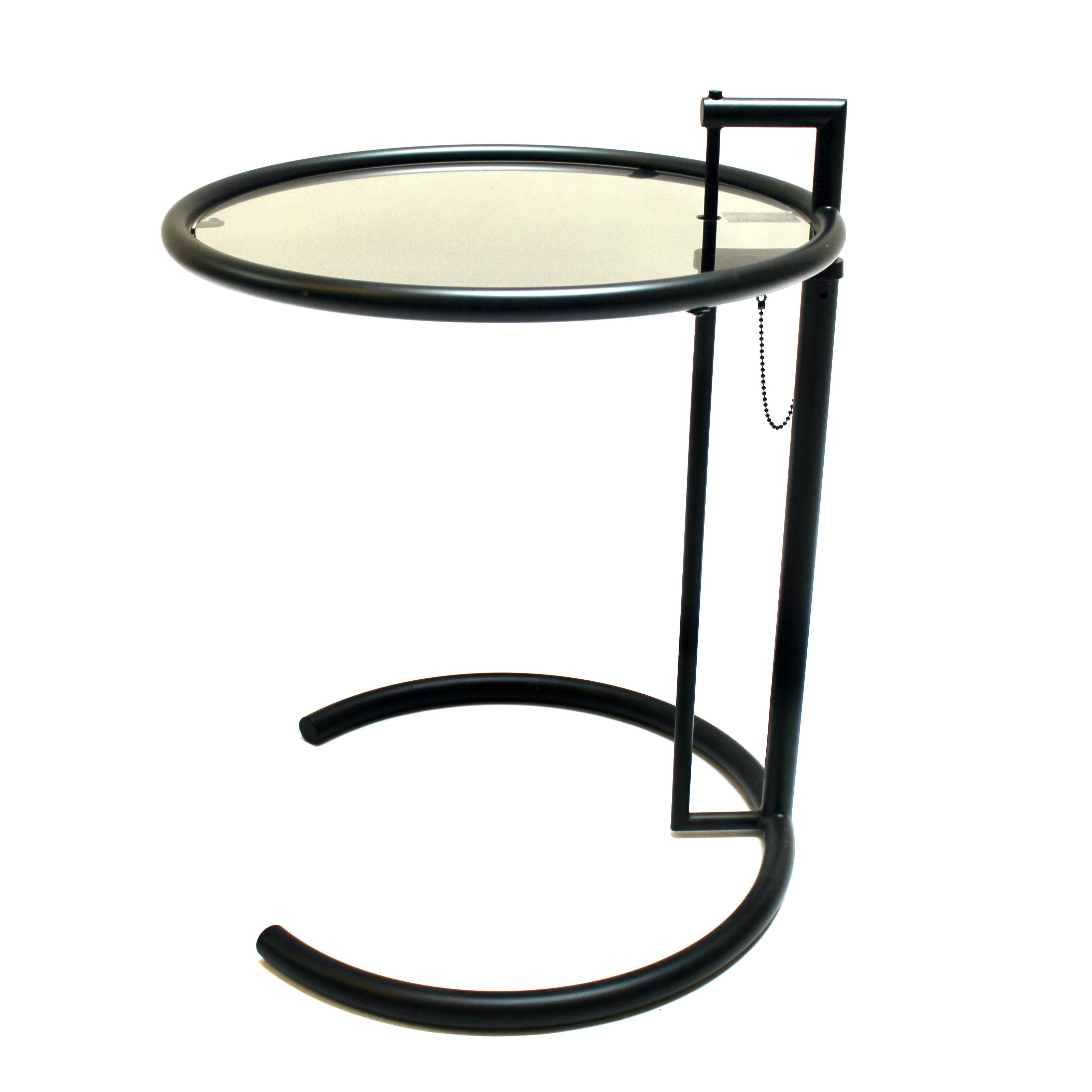 Eileen Gray E1027 adjustable black metal and smoked glass side table. This model is officially licensed by Aram Design Ltd. and manufactured by ClassiCon in Italy. The height adjusts from 25 inches to a maximum of 40 inches. In excellent condition,