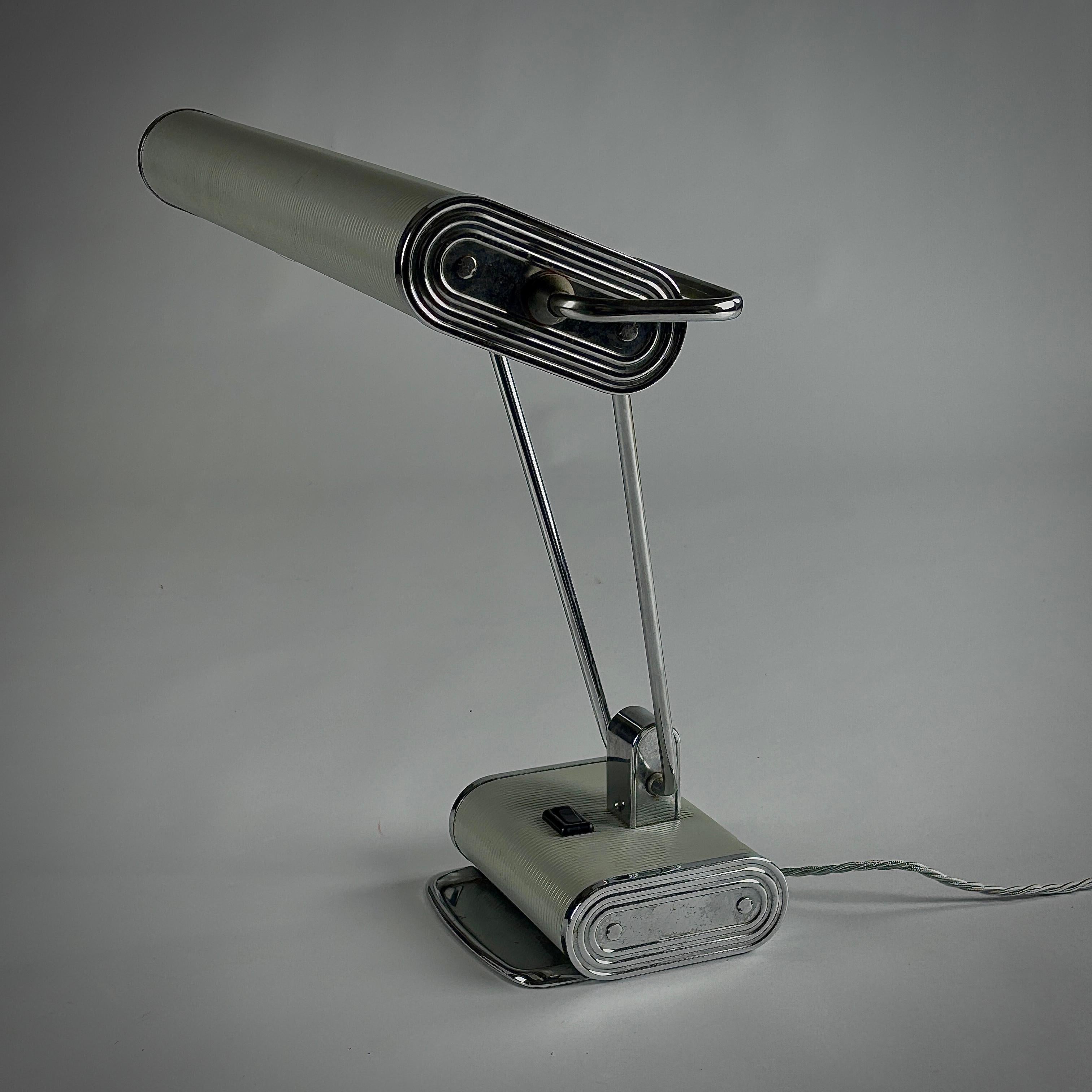 Eileen Gray No.71 Lamp by Jumo. This lamp showcases the minimalist, functional elegance typical of Gray. Sleek lines and adjustable elements reflecting her modernist approach blending art and utility. Unusual polished Chrome and light grey