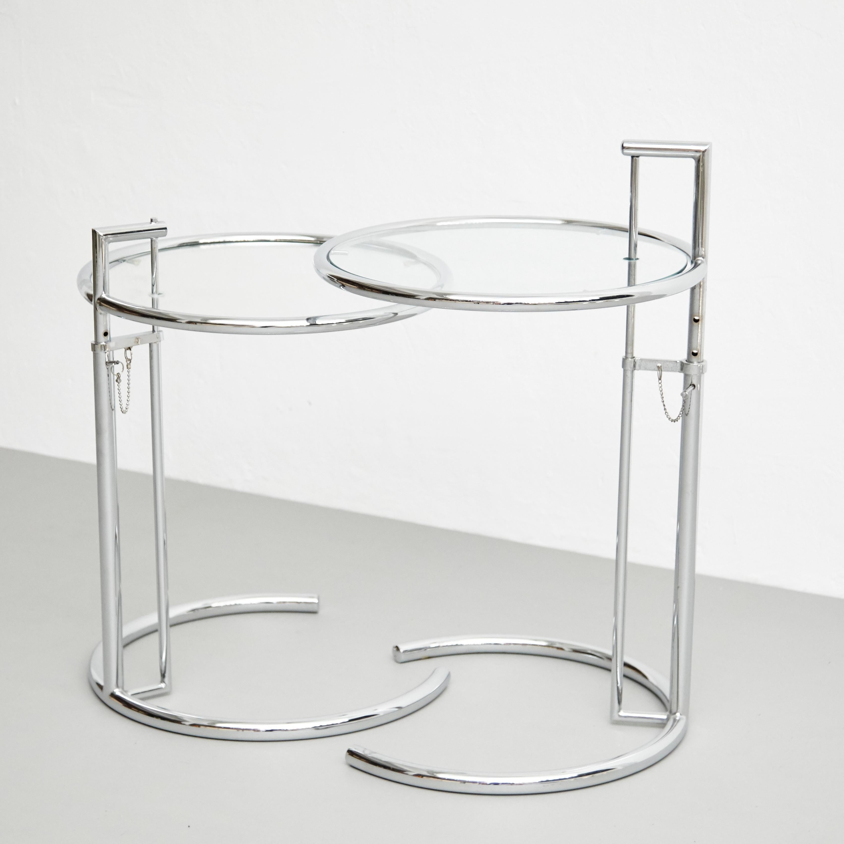 After Eileen Grey pair of E-1027 side tables, circa 1970.
By Unknown manufacturer.

In original condition, with minor wear consistent with age and use, preserving a beautiful patina. 

Its proportioned and distinctive form has made this