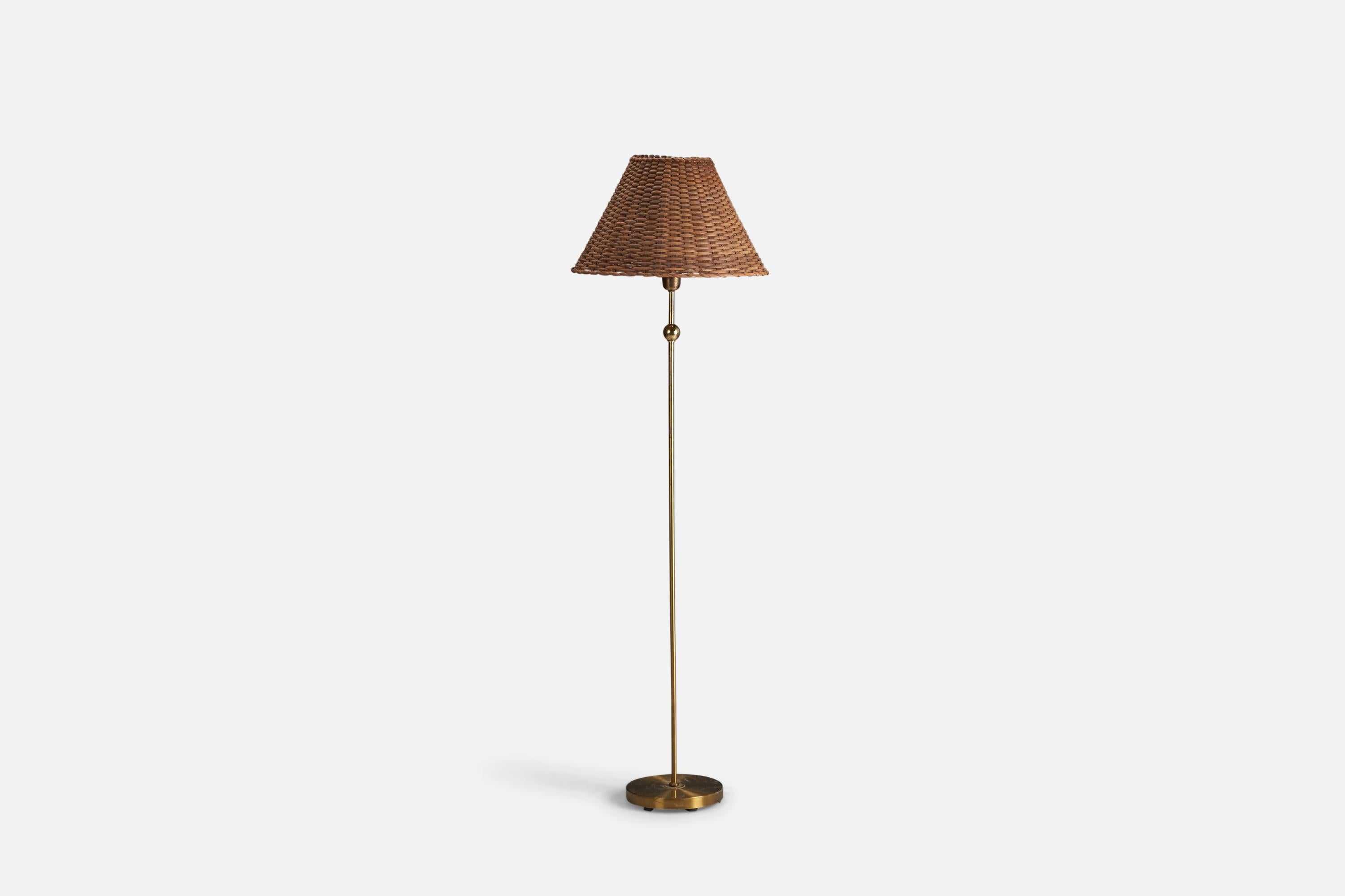 A brass and rattan floor lamp designed and produced by Einar Bäckström, Sweden, 1950s.

Socket takes standard E-26 medium base bulb.

There is no maximum wattage stated on the fixture.