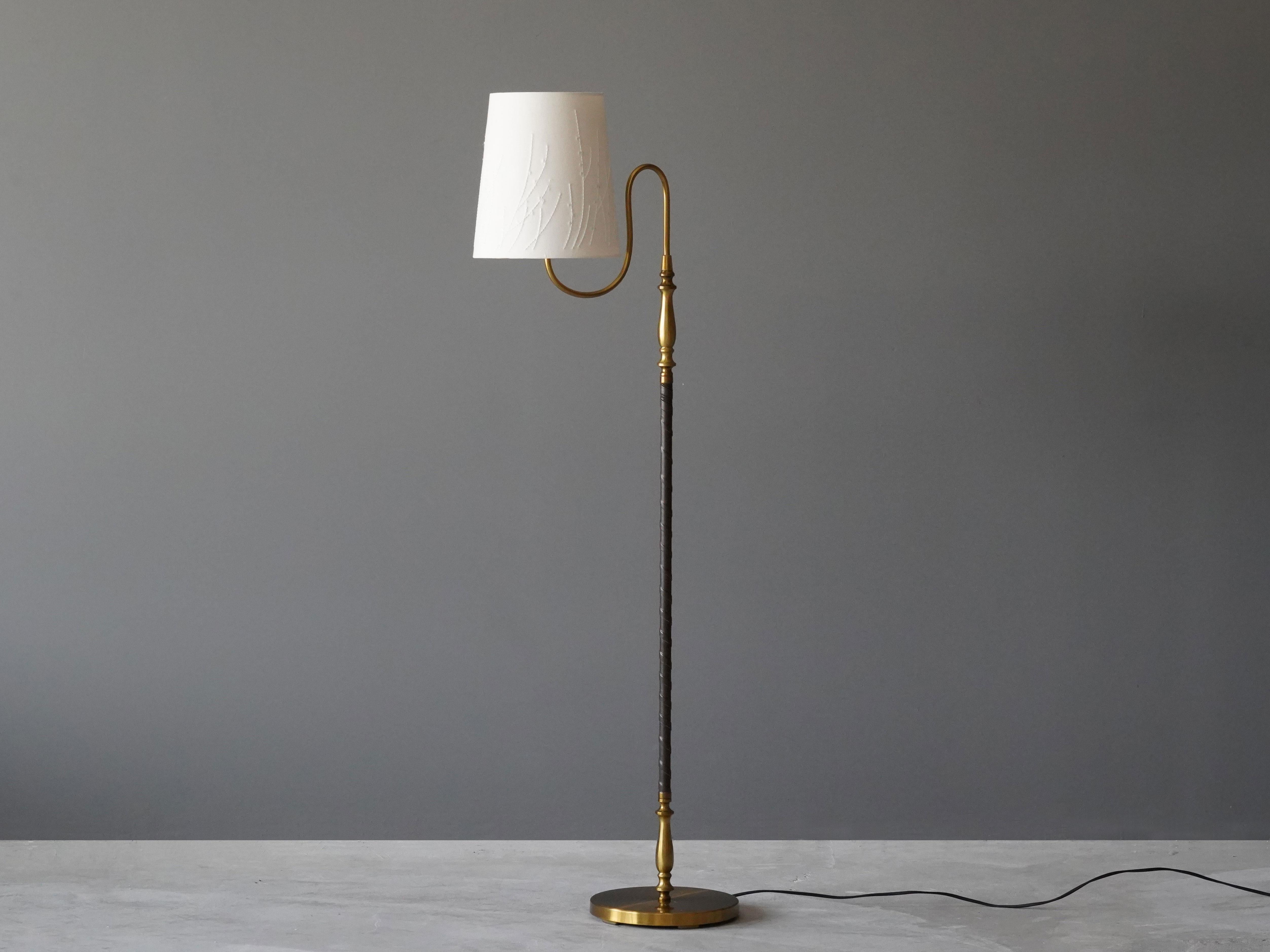 A rare adjustable floor lamp with an organic arm.

Fabric screen with handstitched detail, brass and original dark brown leather. 

Other designers of the period include Paavo Tynell, Josef Frank, Carl-Axel Acking, Alvar Aalto, and Bertil