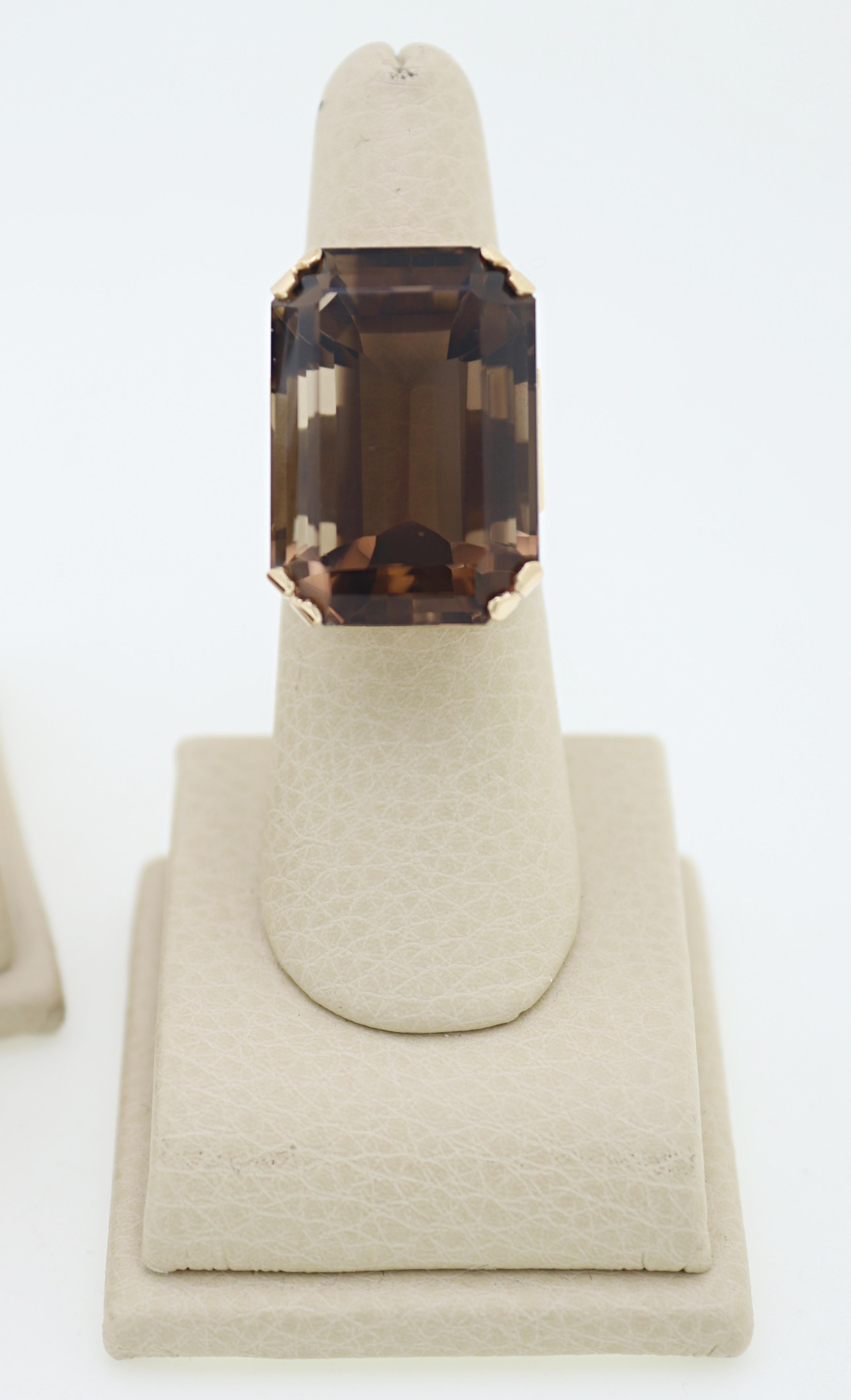 Composed of one 70 ct. emerald-cut smoky quartz, 14k yellow gold pendant; one 39 ct.
emerald-cut smoky quartz, 14k yellow gold ring, size 6.5; together with a matching pair of 11 ct.
tw., emerald-cut smoky quartz, 14k yellow gold non-pierced