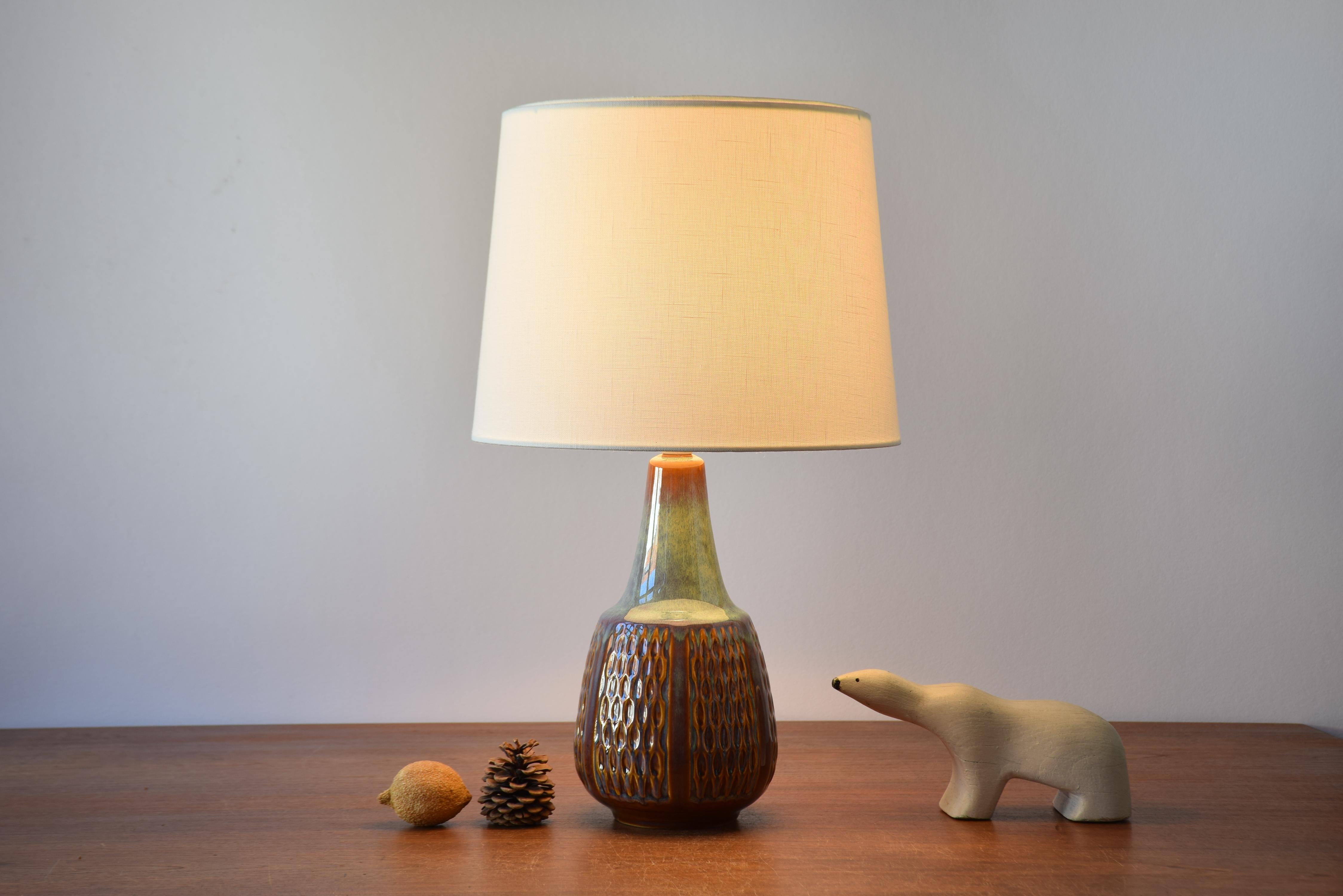 Rare mid-century Danish table lamp from the acknowledged stoneware manufacturer Søholm. Made circa 1960s.

Tall ceramic table lamp designed by Einar Johansen for Søholm, Denmark. Made ca. 1960s.

The glaze of the lamp remind of the Nordic light
