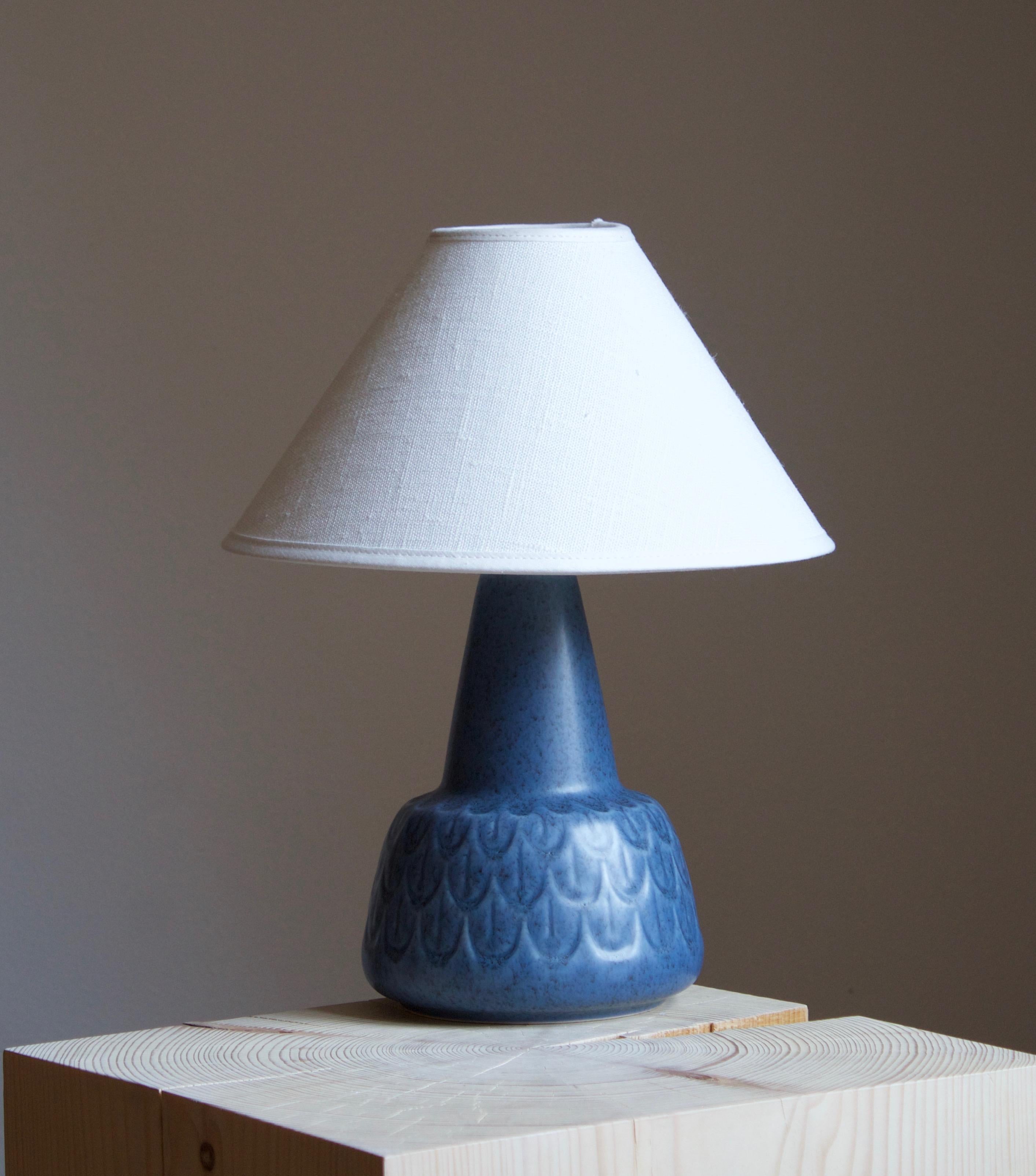 A table lamp produced by Søholm Keramik, located on the island of Bornholm in Denmark. Features a highly artistic glazed and incised decor. 

Sold without lampshade. Stated dimensions exclude the lampshade. Height includes socket.

Glaze features a