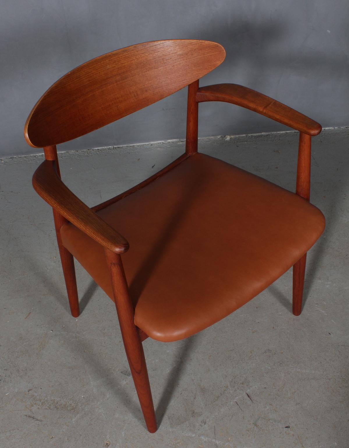 Einer Larsen & Aksel Bender Madsen armchair new upholstered with tan aniline leather.

Frame of teak.

Model 1656, made by Næstved Møbelfabrik.