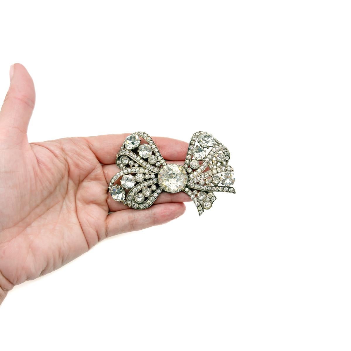 A Vintage Eisenberg Original Bow Brooch. An ultra-rare treasure from the golden age of costume jewellery - this stunning 1940s vintage Eisenberg Original bow brooch is a true collector’s dream. Crafted in solid, weighty sterling silver and dripping