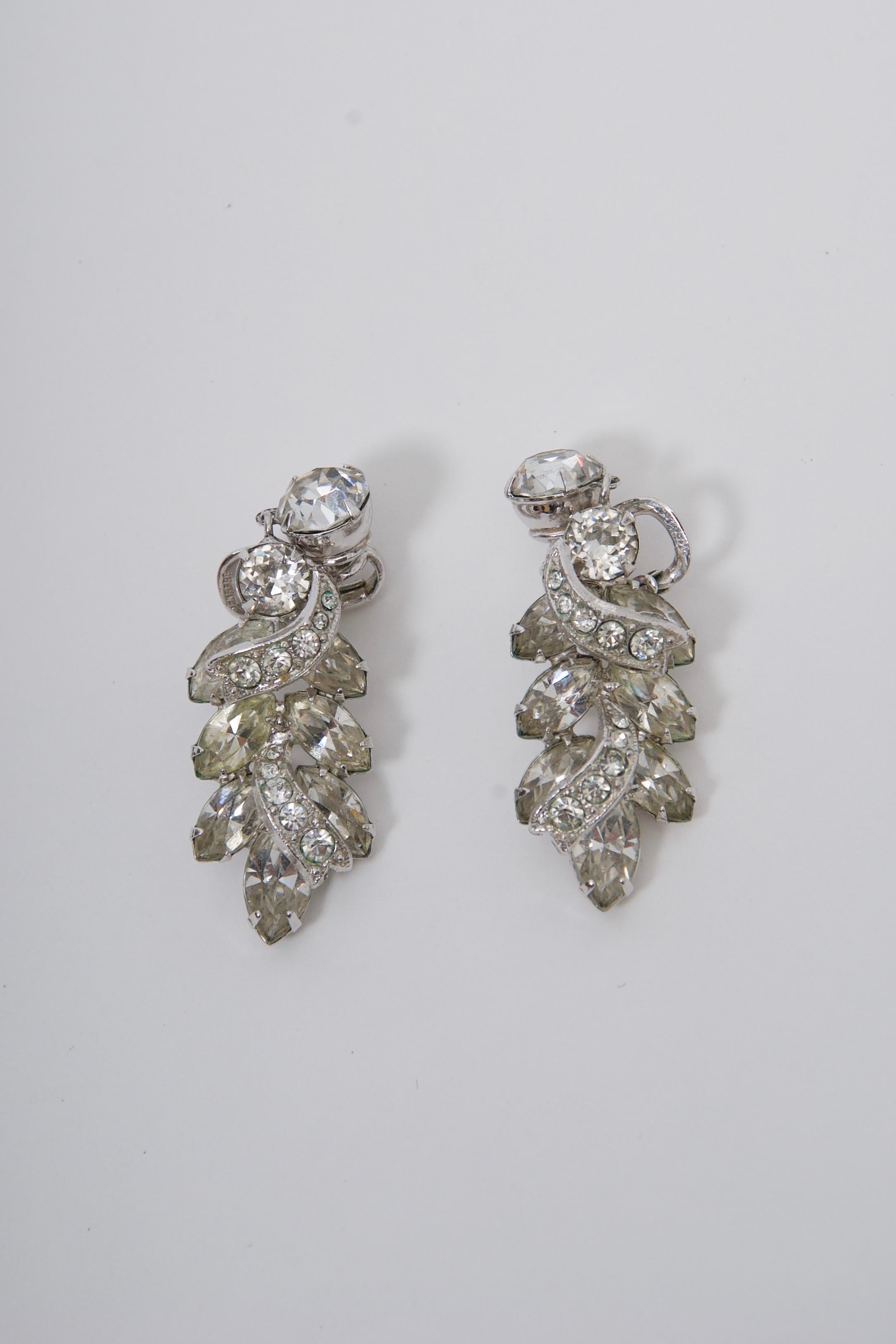 Rhinestone vintage drop earrings by Eisenberg composed of various-sized round and marquise stones in an intricate setting. Comfortable clip-on backings.