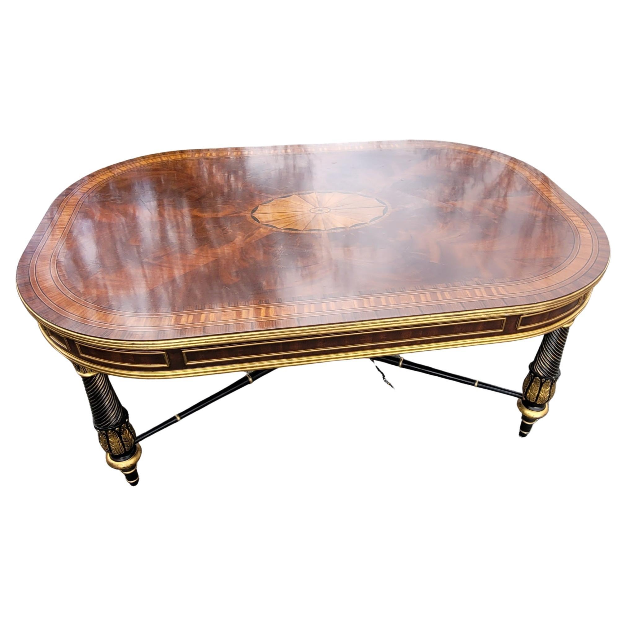 Absolutely gorgeous E.J Victor Regency Style Ebonized and Parcel Gilt Marquetry Inlaid Coffee Table. Features Flame mahogany top with a large center medallion inlaid with satinwood. Gilt decorated Mahogany apron. Very solid construction with large