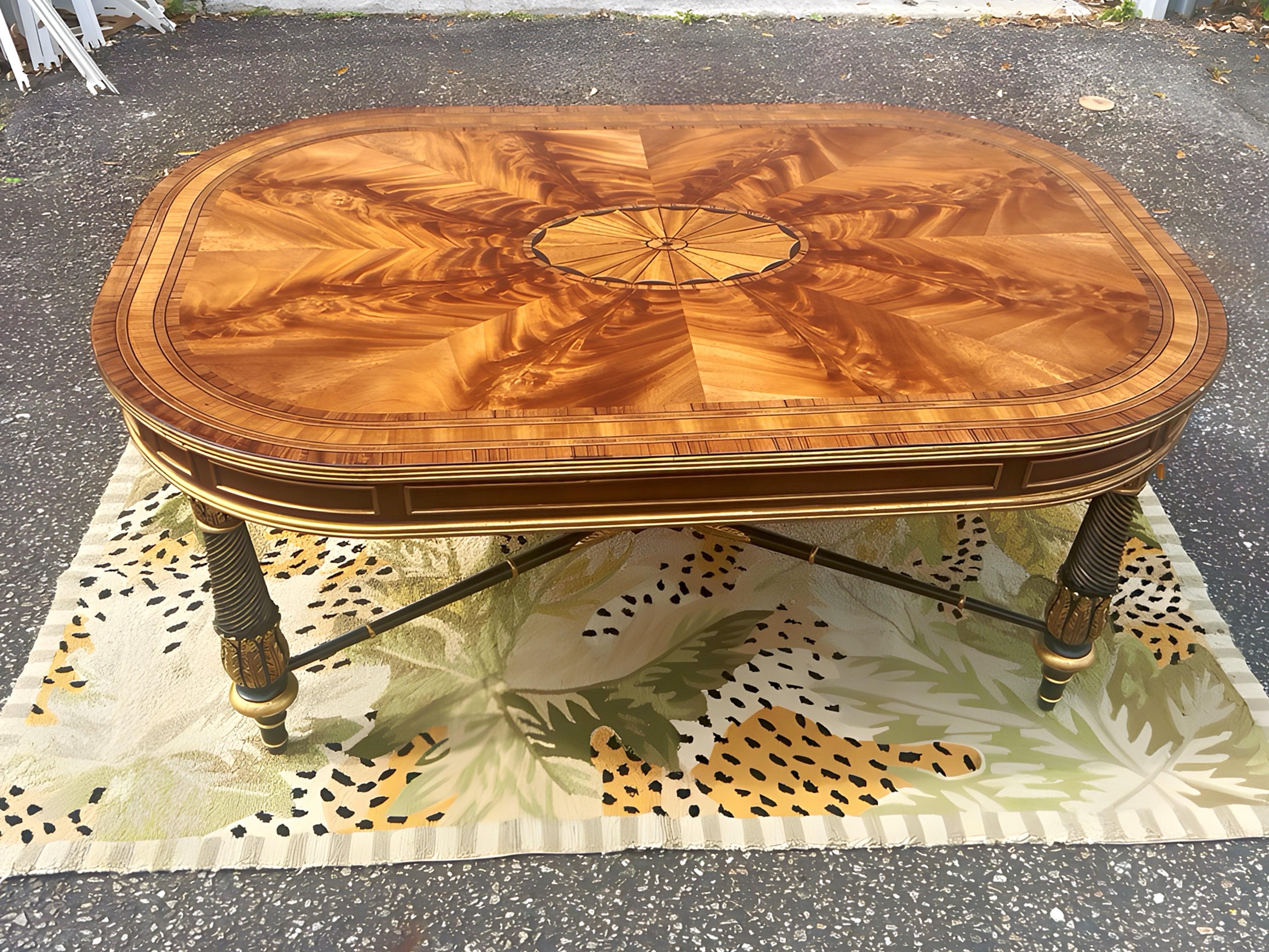 Absolutely gorgeous E.J Victor Regency Style Ebonized and Parcel Gilt Marquetry Inlaid Coffee Table. Features Flame mahogany top with a large center medallion inlaid with satinwood. Gilt decorated Mahogany apron. Very solid construction with large