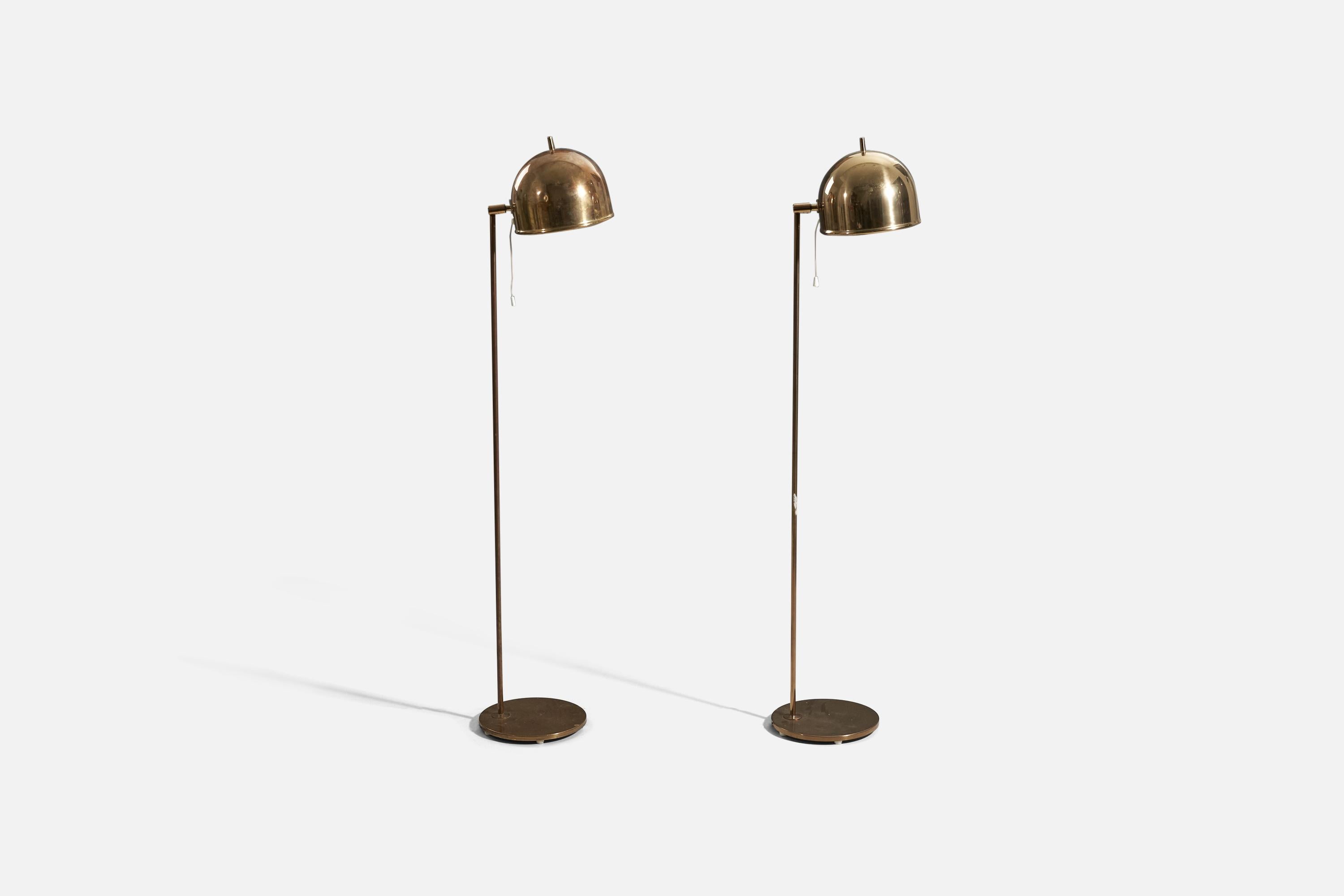 A pair of adjustable brass floor lamp designed by Eje Ahlgren and produced by Bergboms, Sweden, c. 1970s. 

Variable dimensions. Dimensions listed refer to the lamp mounted as illustrated in the first image. 
