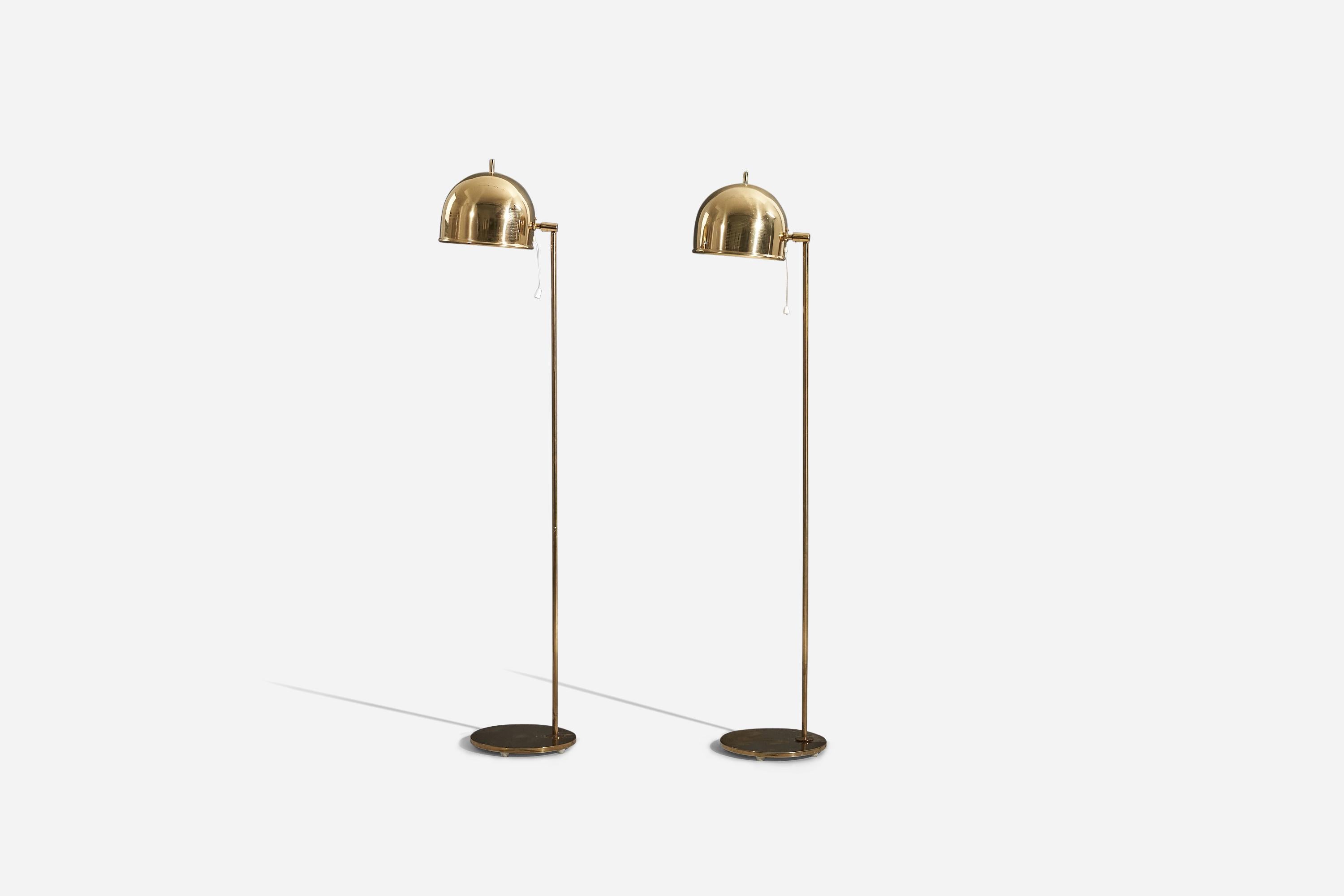 A pair of adjustable brass floor lamp designed by Eje Ahlgren and produced by Bergboms, Sweden, c. 1970s. 

Variable dimensions. Dimensions listed refer to the lamp mounted as illustrated in the first image. 

