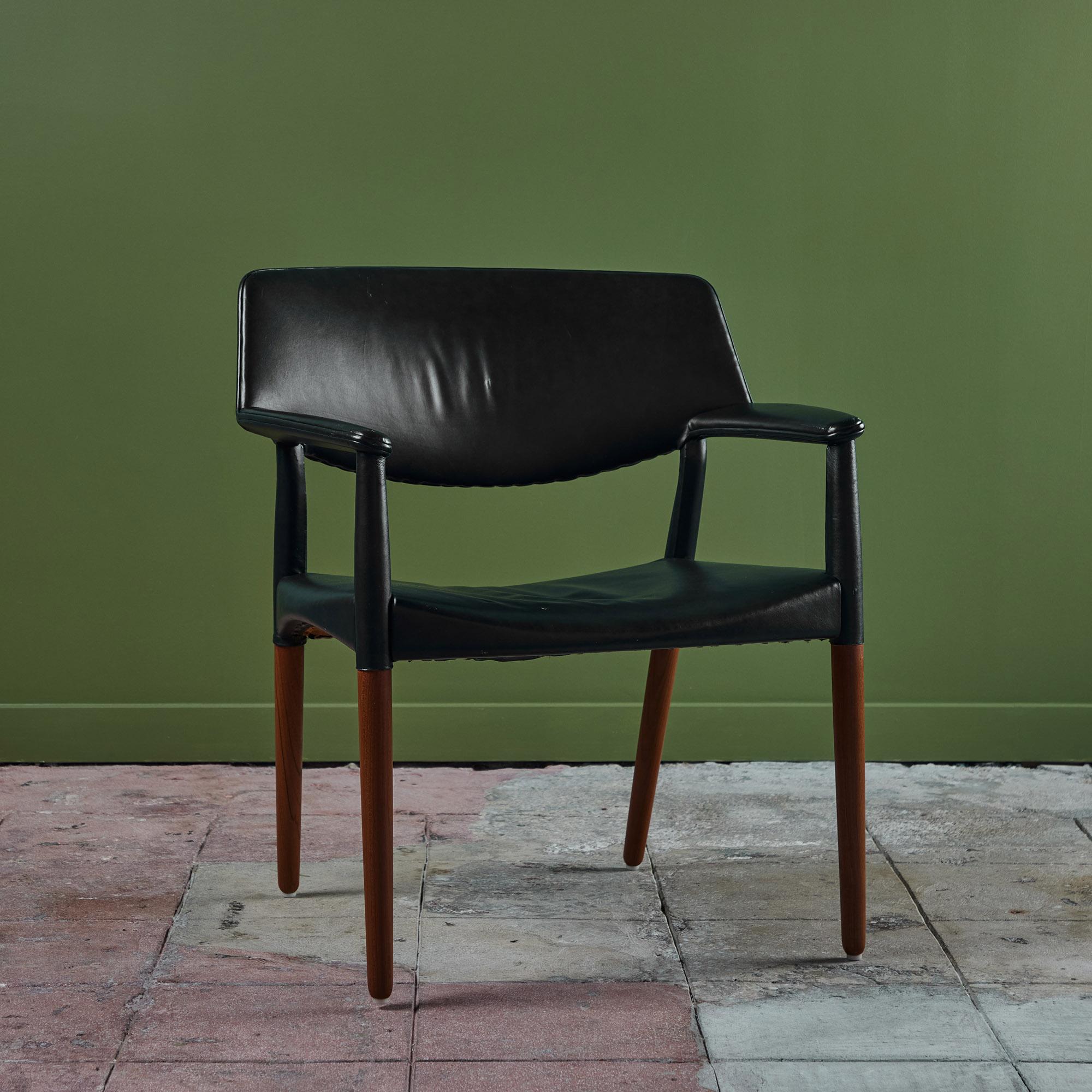 Armchair by Ejner Larsen & Aksel Bender Madsen for Willy Beck, c.1950s, Denmark. The chair features a solid teak frame with a dark navy leather upholstered wide seat, backrest and leather wrapped armrests.

Dimensions 
27.5” width x 21” depth x