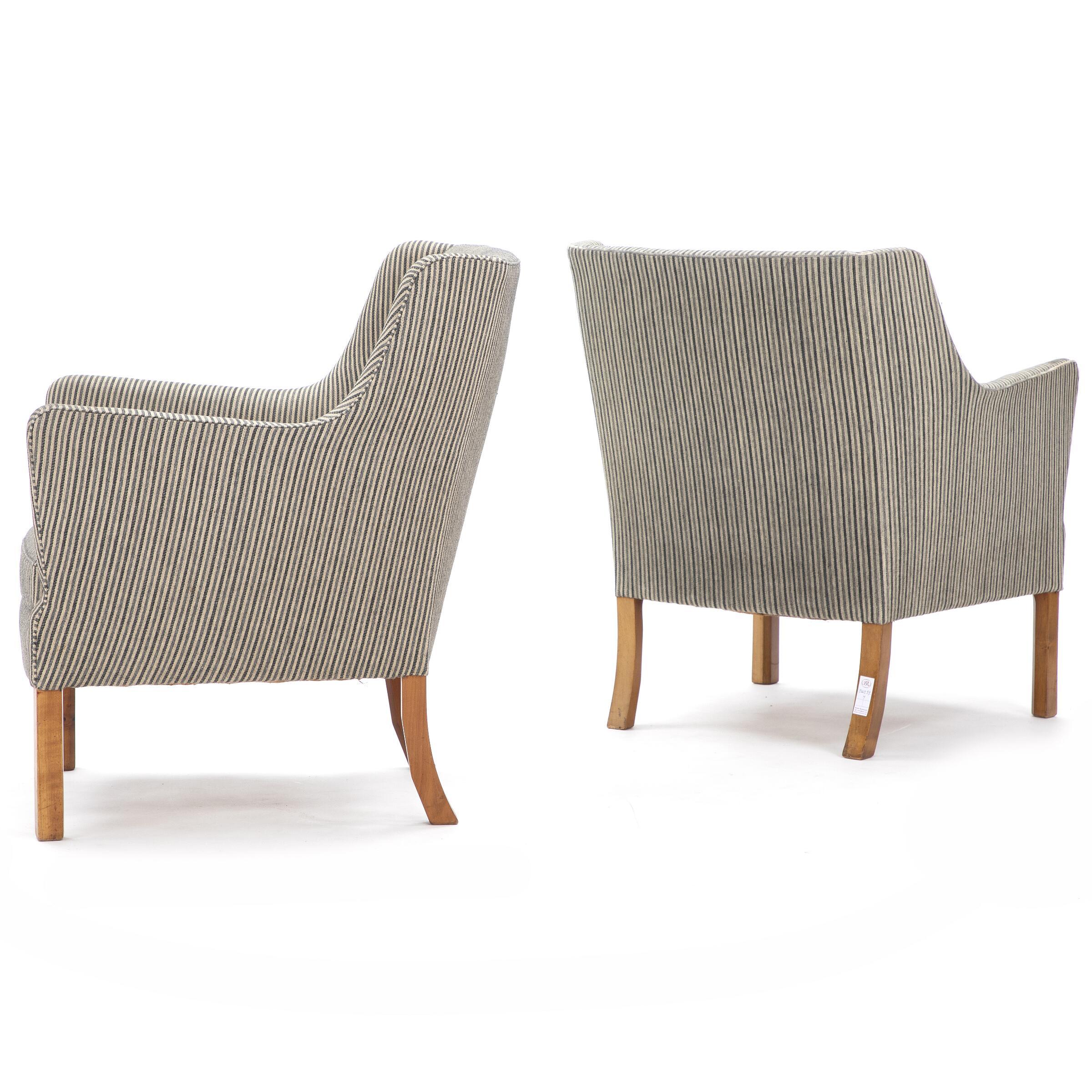 Ejner Larsen: pair of striped wool and mahogany easy chairs. Designed 1945. Made by cabinetmaker Jacob Kjær. 

Wear due to age and use, including scratches and marks on legs. One chair missing button in back. Wool with stains and dirt. One chair