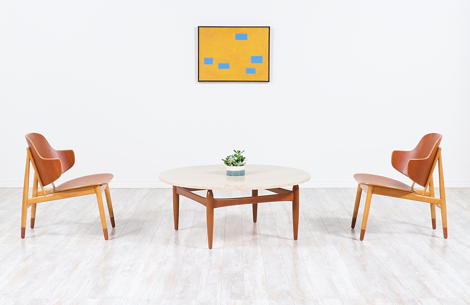 Beautiful Danish modern coffee table designed by Ejvind A. Johansson in collaboration with Danish company, Ludvig Pontoppidan from Denmark in the 1960s. Our elegant table features a solid structured teak wood base with uniquely sculpted tapered legs