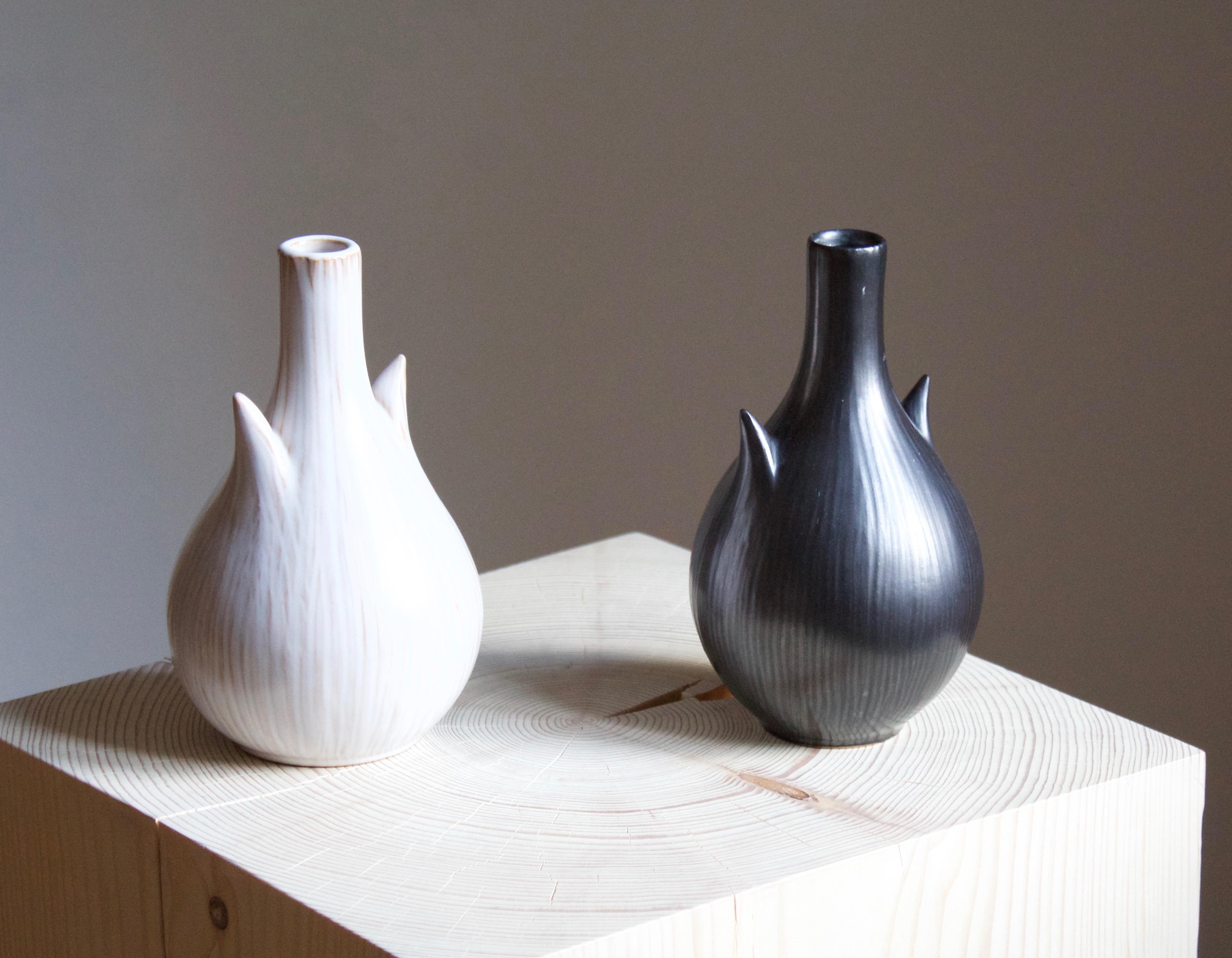 A pair of vases. Produced by Ejvind Nielsen in his studio in Hvidovre, Denmark. Produced circa 1950s-1960s. Signed.