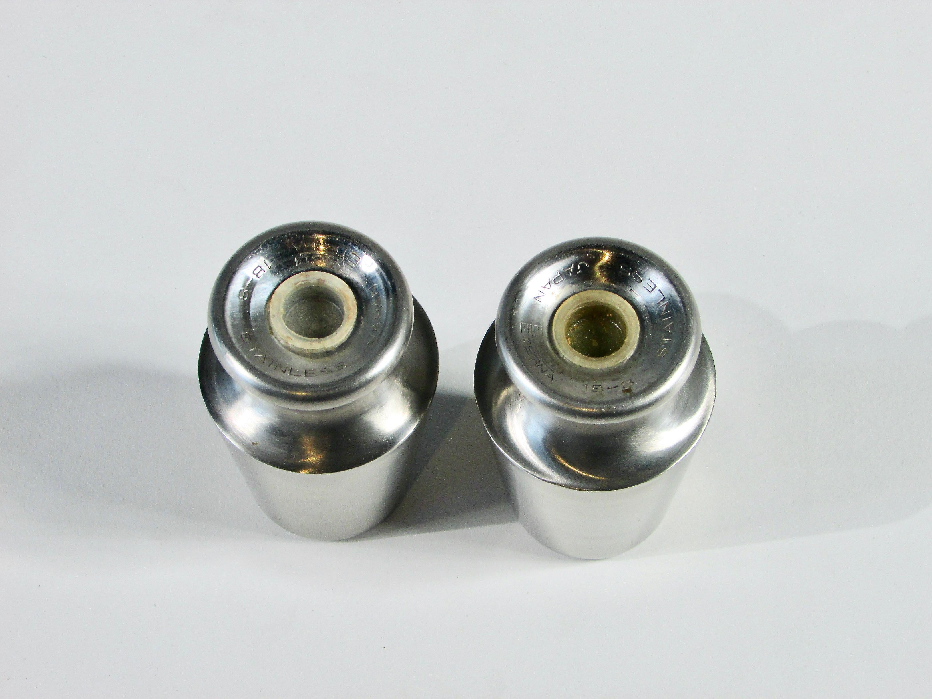 Pair of pedestal base modernist stainless steel salt pepper shakers. Marked 8/18 stainless Ekco Eterna Japan.