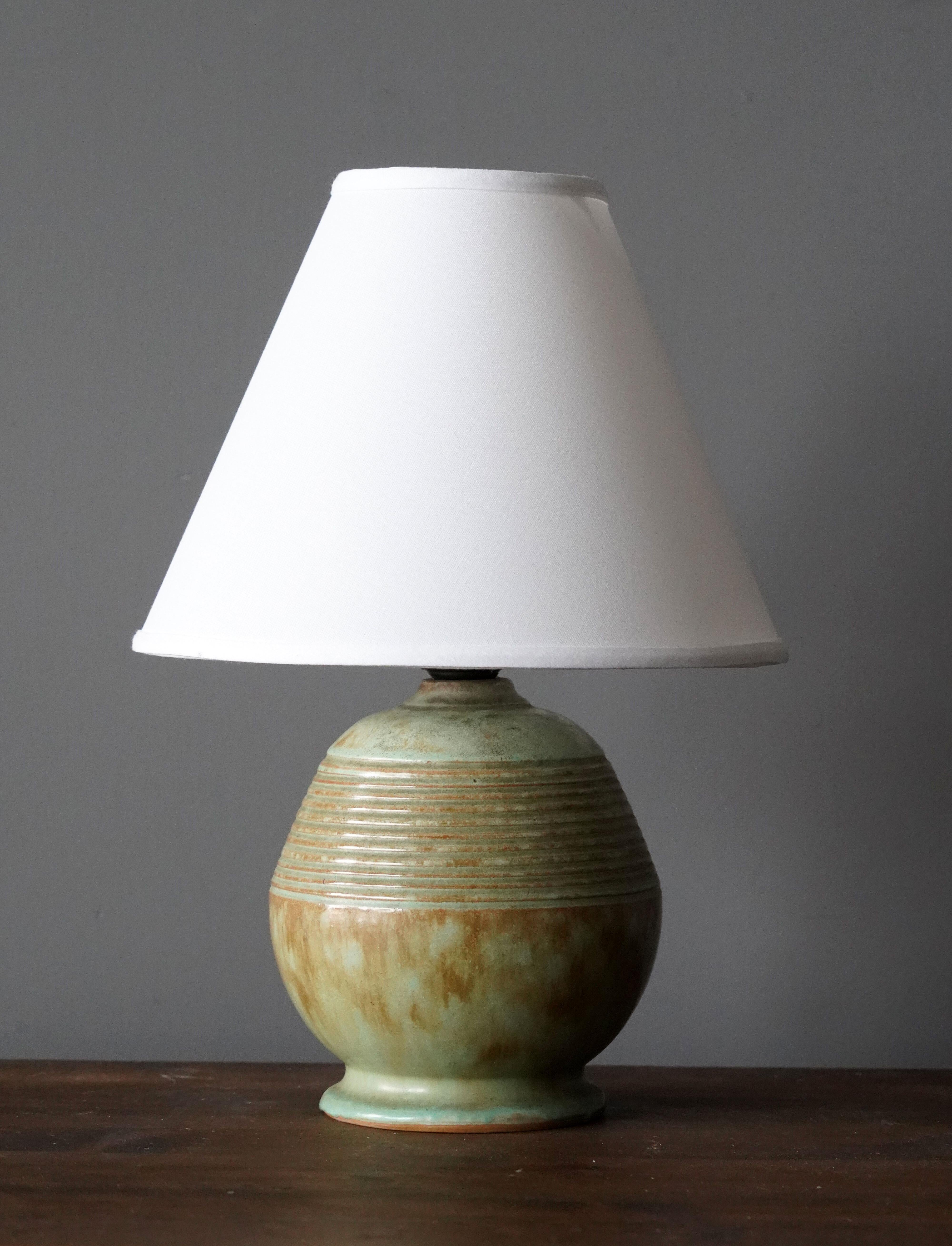 A table lamp, production attributed to iconic Swedish firm Ekeby. In glazed stoneware.

Sold without lampshade, stated dimensions excluding lampshade.

Other designers of the period include Axel Salto, Carl Harry Stålhane, Berndt Friberg, Lisa