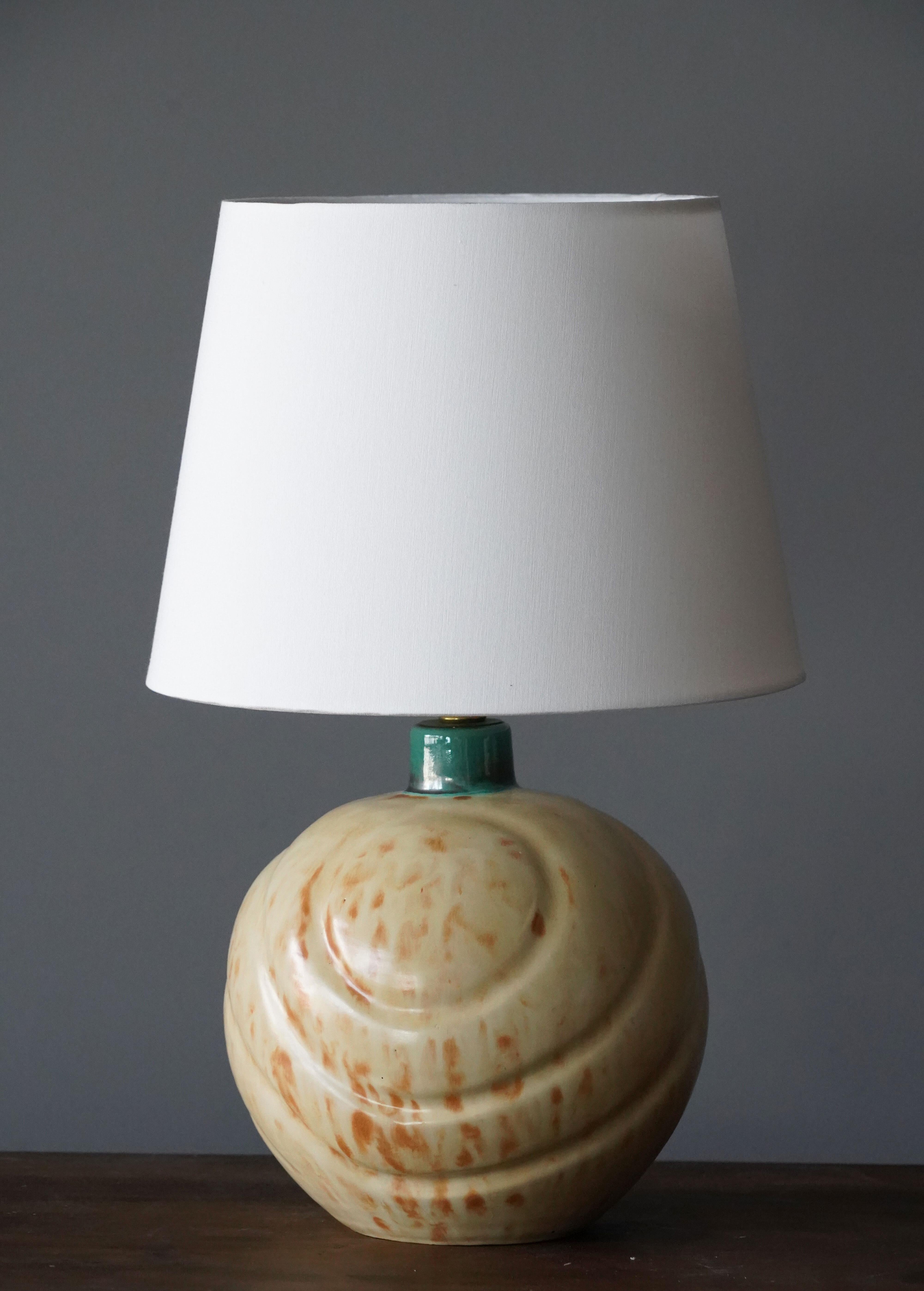 A sizable table lamp by iconic Swedish ceramic firm Ekeby. In glazed stoneware. Marked and dated.

Sold without lampshade, stated dimensions excluding lampshade.

Other designers of the period include Axel Salto, Carl Harry Stålhane, Berndt
