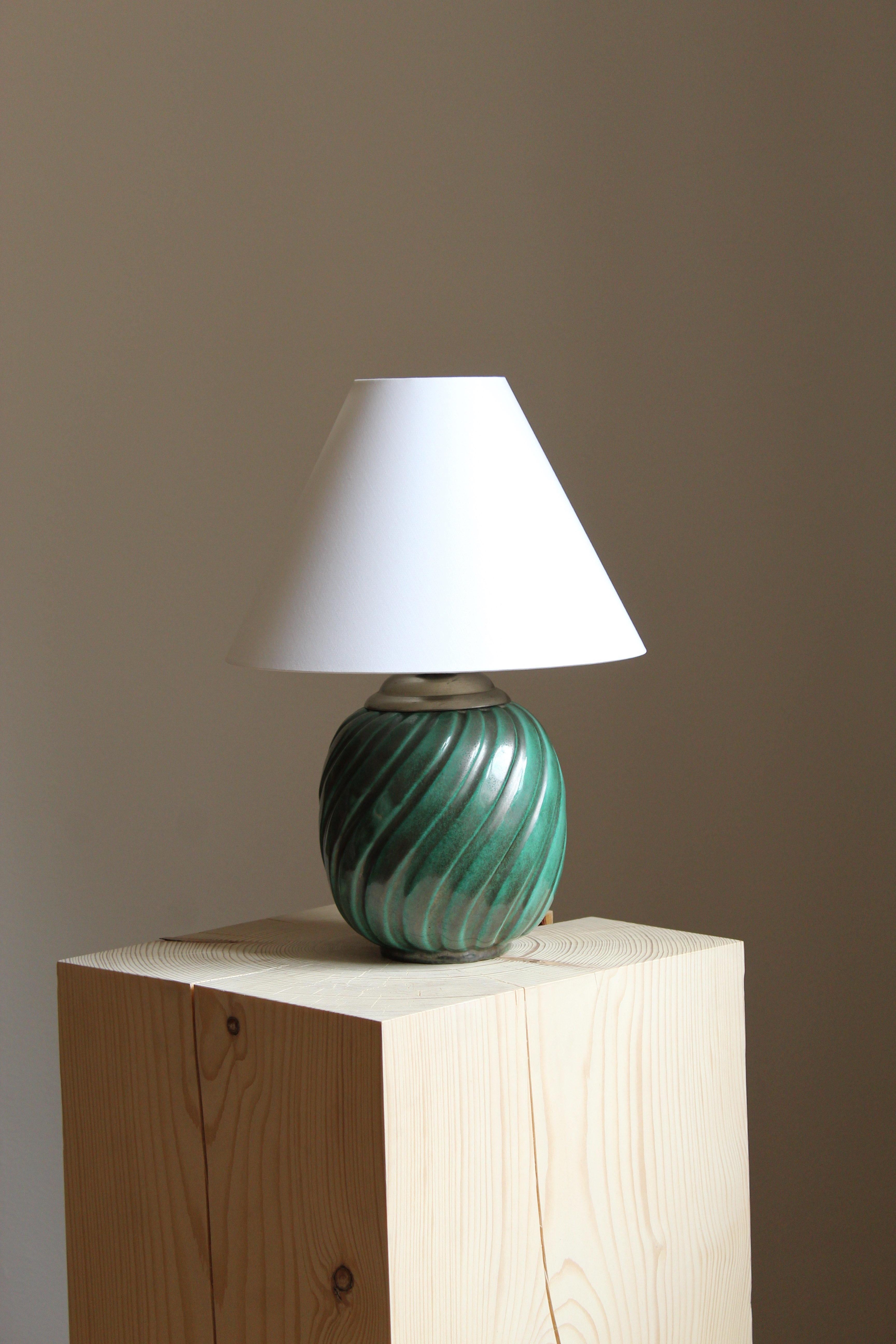 A sizable table lamp by iconic Swedish ceramic firm Ekeby. In glazed stoneware. Marked.

Sold without lampshade, stated dimensions excluding lampshade. 

Other designers of the period include Axel Salto, Carl Harry Stålhane, Berndt Friberg, Lisa