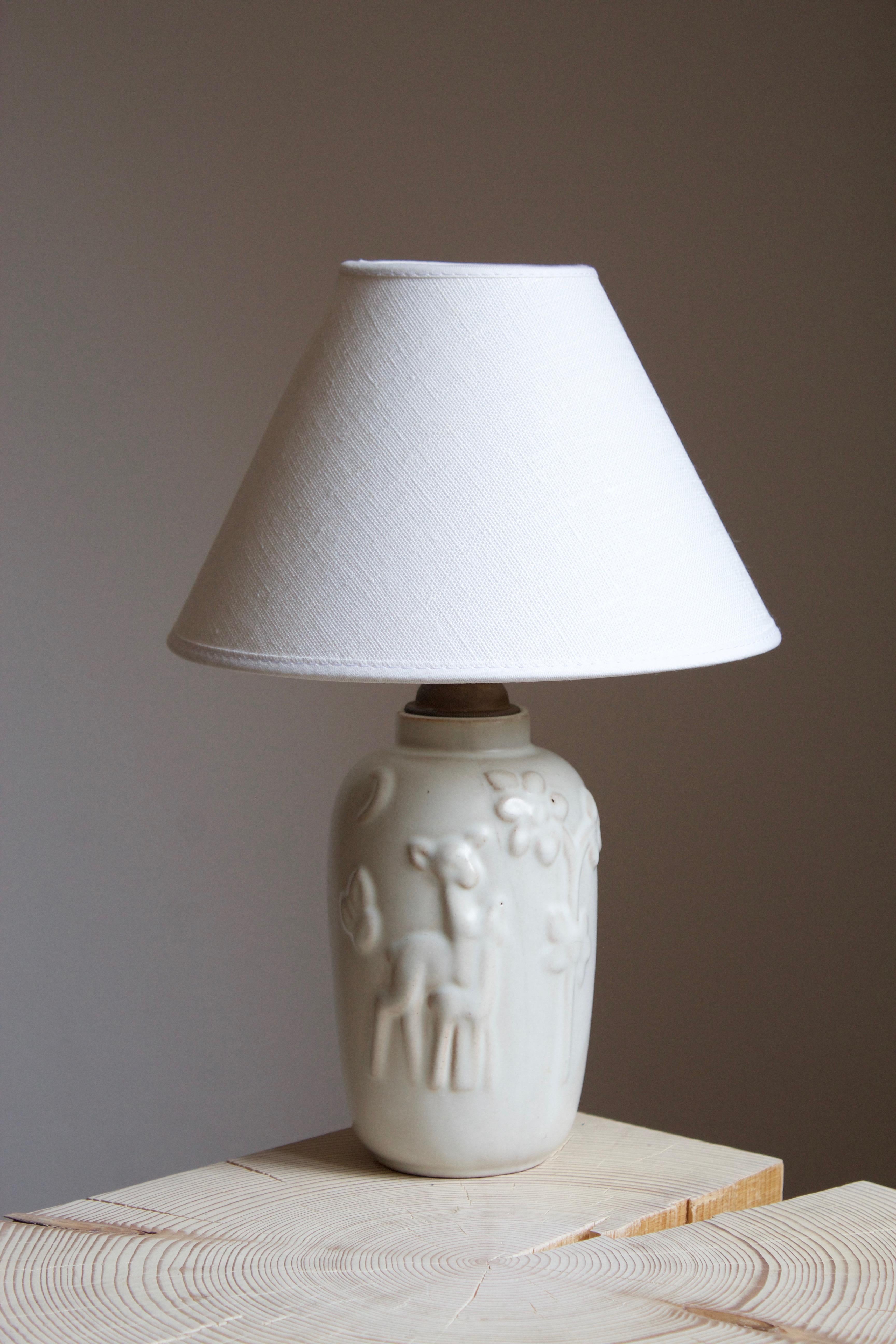 A table lamp by Swedish ceramic firm Ekeby. In glazed ceramic.

Sold without lampshade. Stated dimensions exclude lampshade. Height includes socket. Sold without lampshade.

Glaze features a white color.

Other designers of the period include Axel