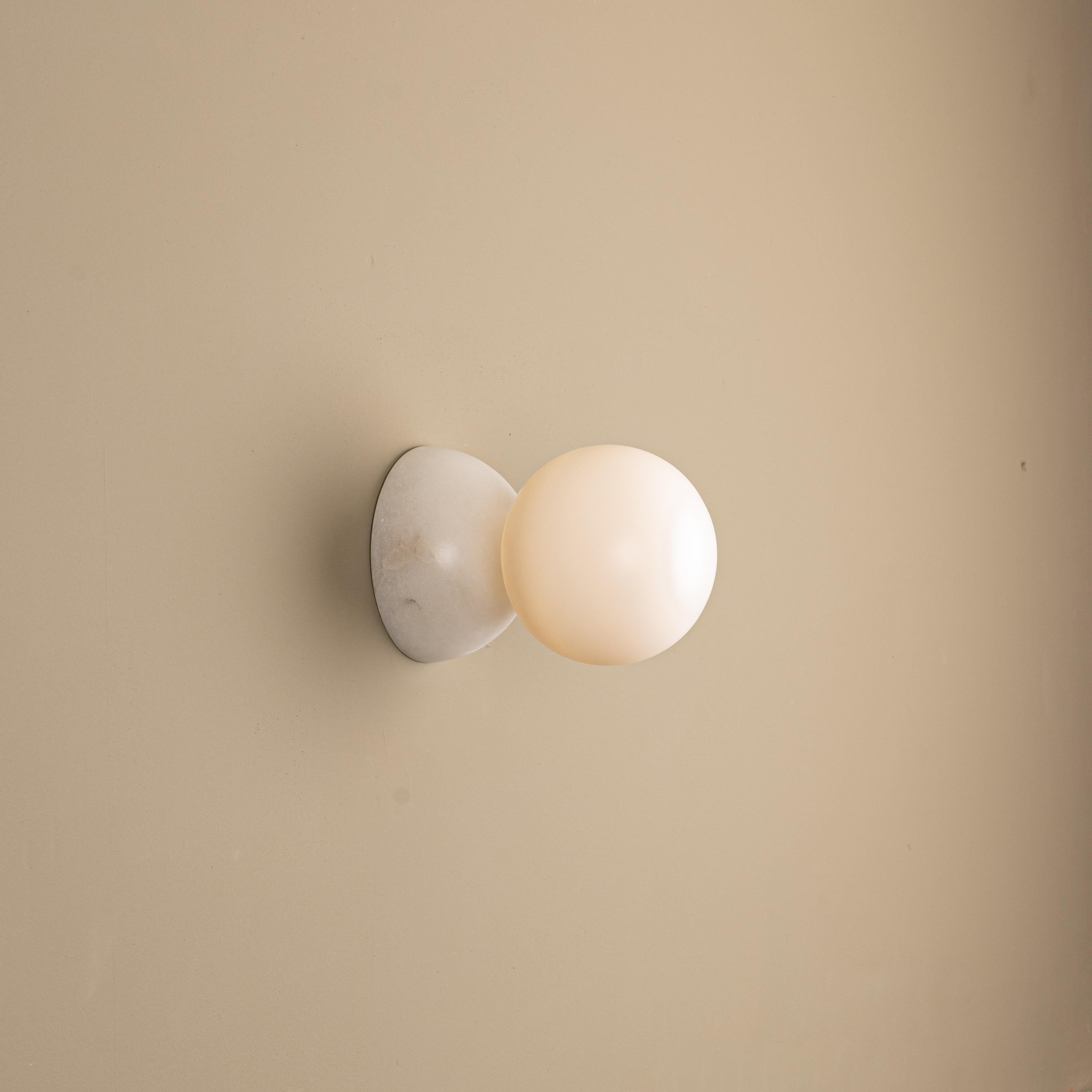 Eklipso White Alabaster Wall Sconce by Simone & Marcel
Dimensions: D 19,5 x W 14 x H 14 cm.
Materials: White alabaster and glass.

Available in different marble, brass, steel and alabaster options and finishes. Custom options available on request.