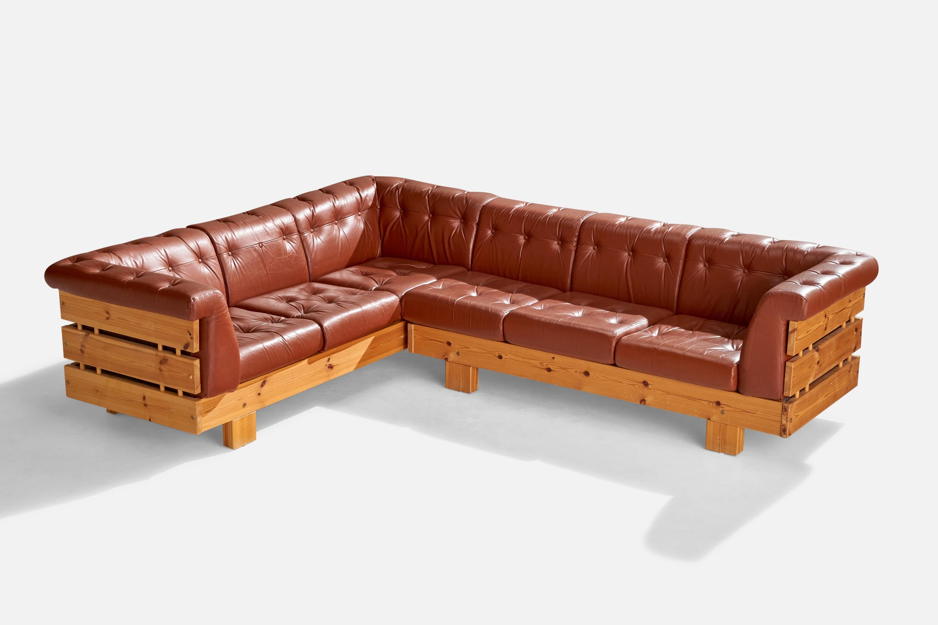 A brown red leather and pine sectional sofa produced by Ekornes Fabrikker, Norway, c. 1970s.

Dimensions: 28.5