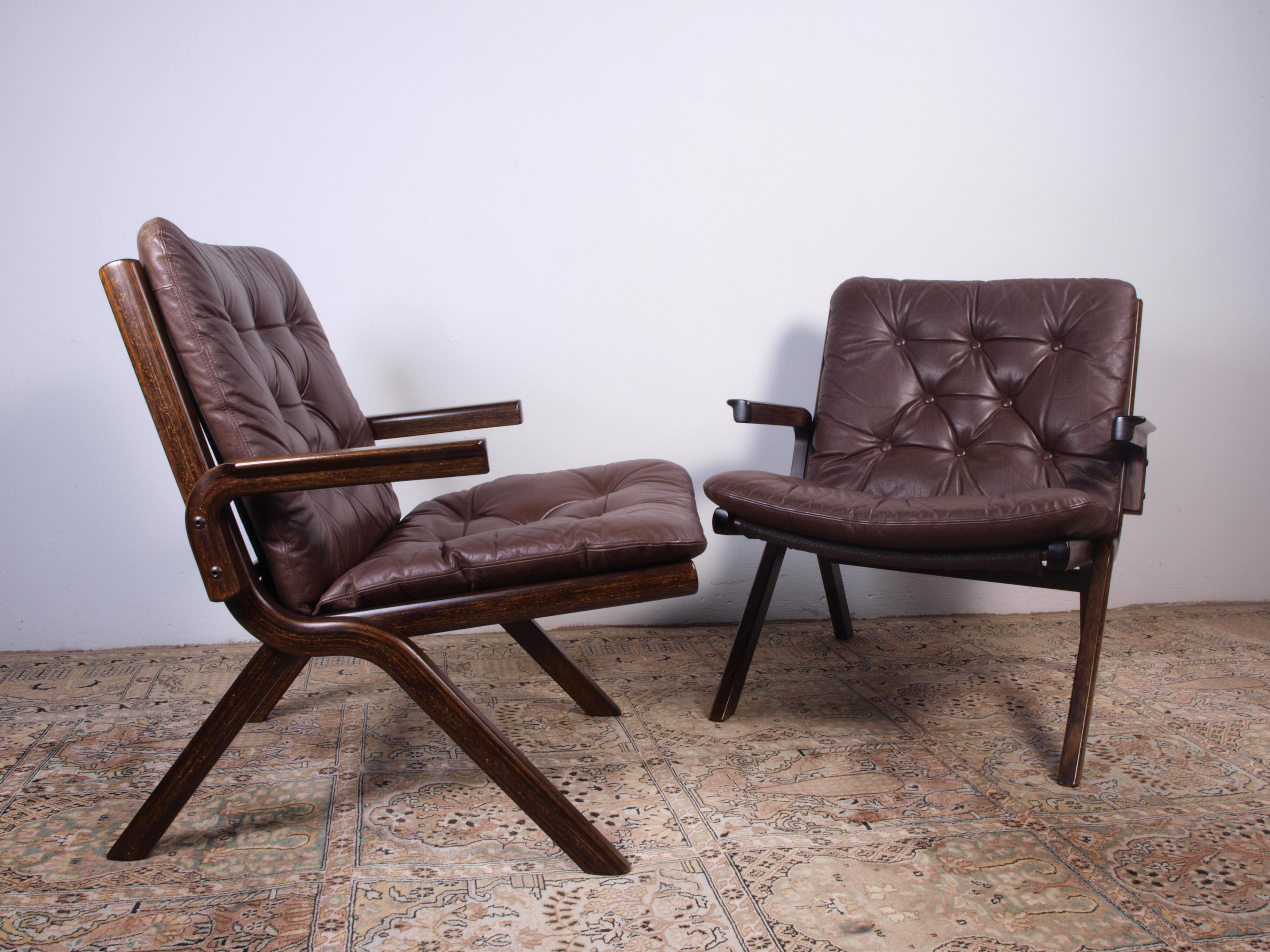 Crafted around 1960s in Norway, this vintage leather chair exudes timeless charm. Its curved, stained beechwood frame boasts a warm auburn tint, complementing the sumptuous brown leather adorning the seat and back. The sinuous design, a hallmark of