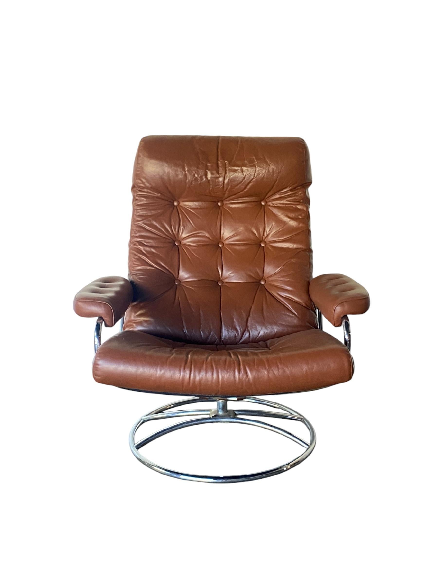 Ekornes Stressless reclining lounge chair and ottoman from the 1970s. Elegant mid century Scandinavian design with tubular bent chrome frame and burnt orange cognac leather cushion. Lounge at any angle in comfort with this timeless design.