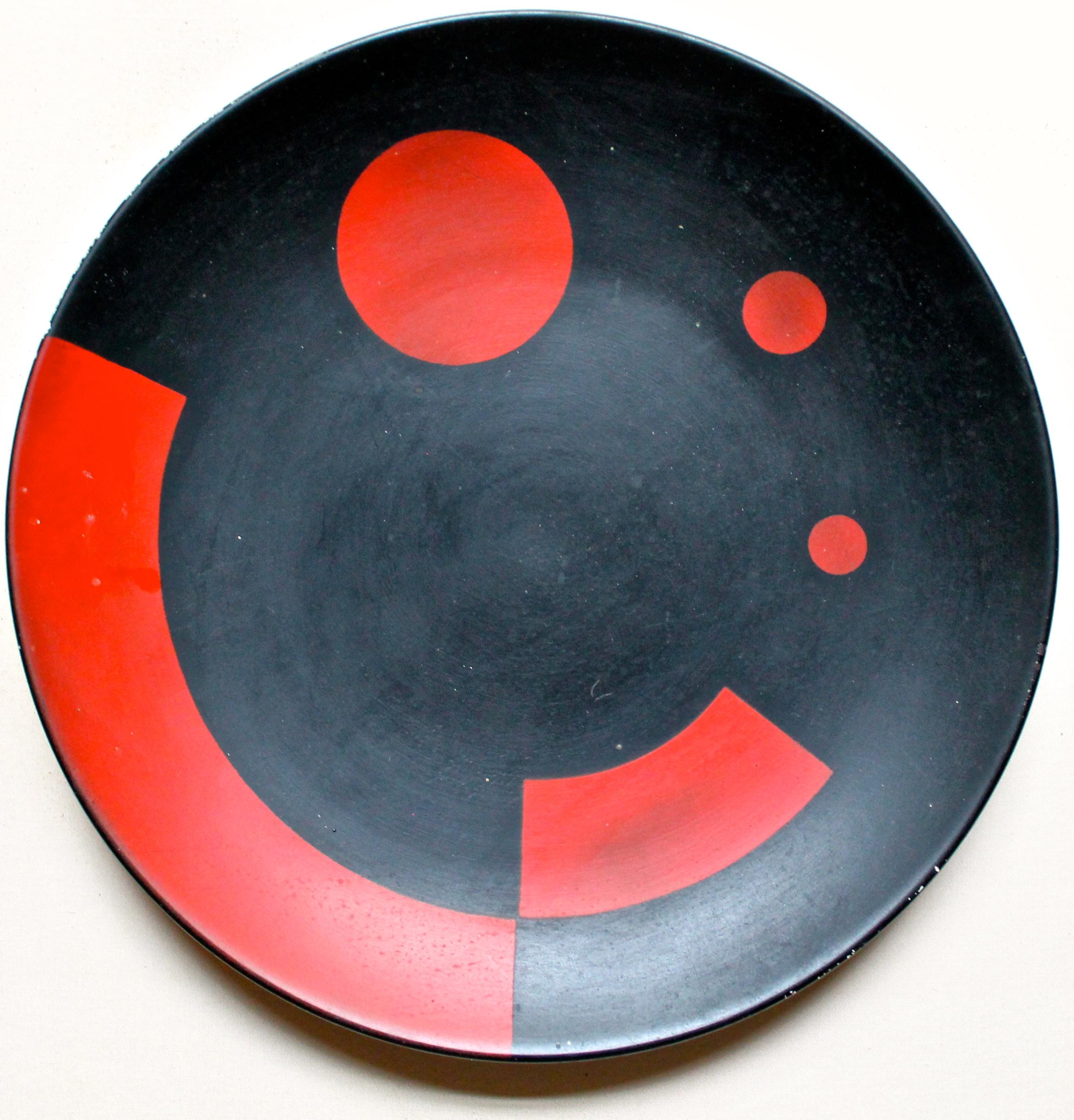 This famous and important modernist icon manufactured in 1925, after the 1923 design by El Lissitzky (Lazar Markovich Lissitzky 1890-1941). Red enamel stencil decoration over black slip.