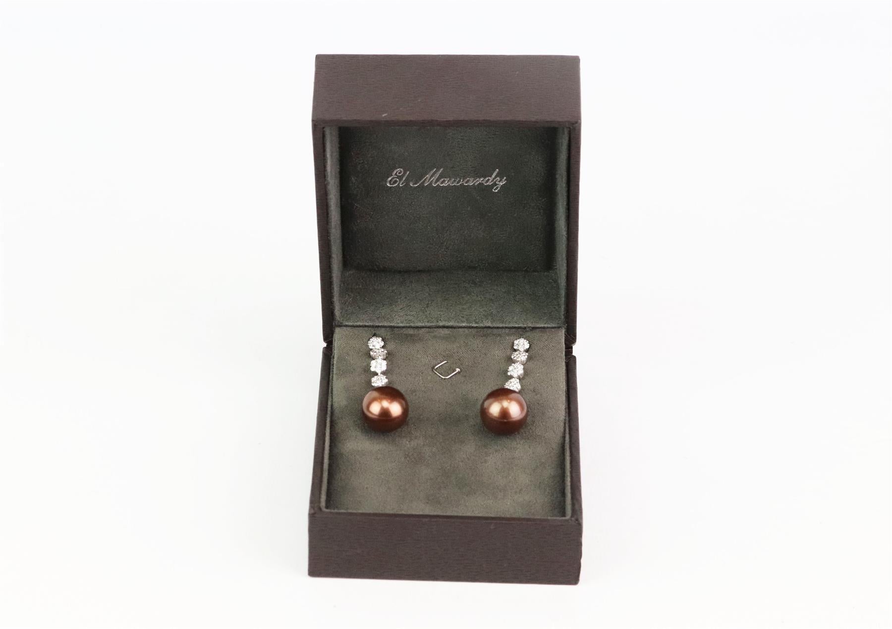 These drop earrings by El Mawardy are made from white gold, these earrings are dusted with shimmering pave diamonds that beautifully illuminate the lustrous brown pearl drops. Brown pearl, white gold, pave diamonds. Butterfly fastening for pierced